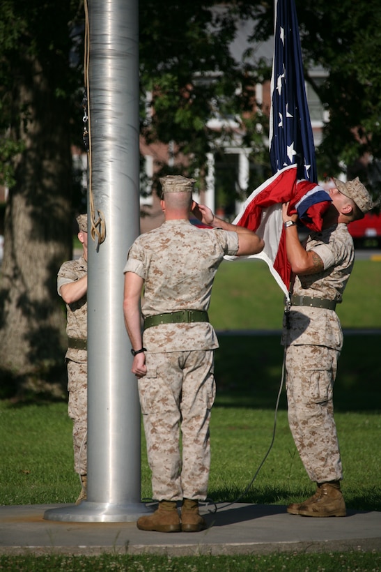 Marines salute the national ensign during evening colors aboard Cherry Point, N.C. According to the order, a salute should be rendered during morning and evening colors.
