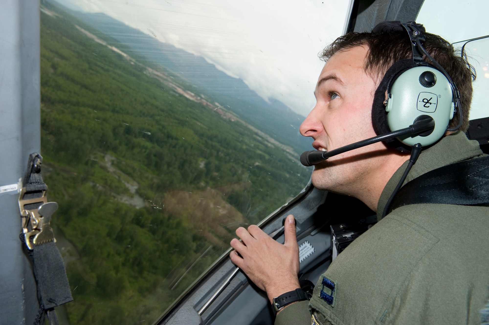 ELMENDORF AIR FORCE BASE, Alaska -- Capt. Dennis Nita looks for other aircraft in the area while flying a C-17 Globemaster III during a training mission in preparation of the Air Mobility Commands Rodeo competition at McChord Air Force Base, Wash., in July. The international competition focuses on readiness, and features airdrops, aerial refueling and other events which will showcase the unique and wide-ranging capabilities of military security forces, and aerial port, maintenance and aeromedical evacuation personnel. Nita is a C-17 pilot assigned to the 517th Airlift Squadron here. (U.S. Air Force photo/Master Sgt. Keith Brown)