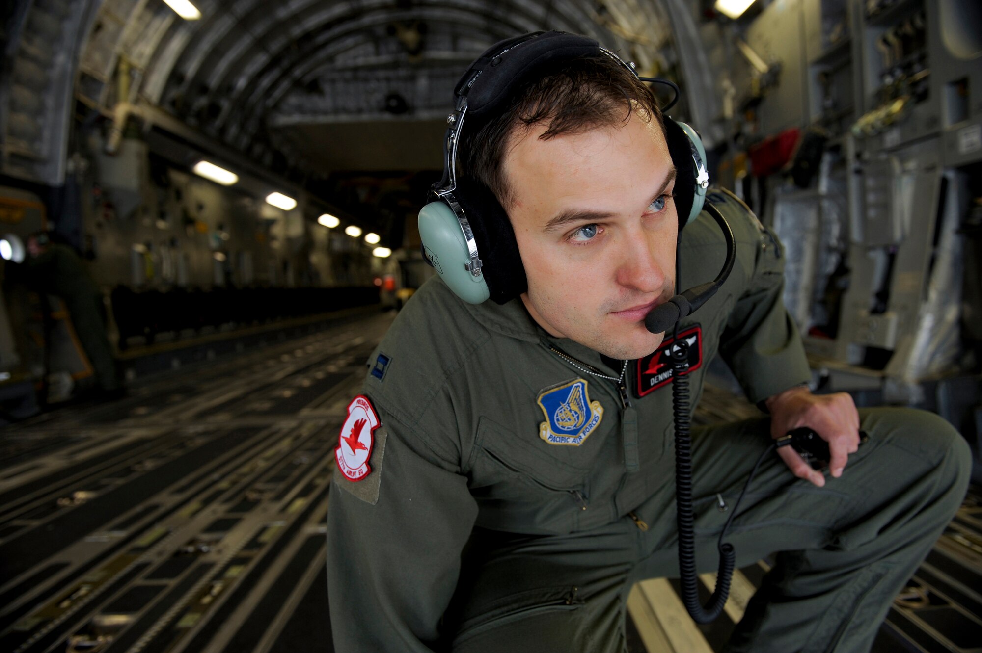 ELMENDORF AIR FORCE BASE, Alaska -- Capt. Dennis Nita watches from the cargo ramp as pilots practice full combat capability maneuvers by rapidly backing and turning a C-17 Globemaster III to stop it within feet of a given point. The training is preparation of the Air Mobility Commands Rodeo competition at McChord Air Force Base, Wash., in July. The international competition focuses on readiness, and features airdrops, aerial refueling and other events which will showcase the unique and wide-ranging capabilities of military security forces, and aerial port, maintenance and aeromedical evacuation personnel. Nita is a C-17 pilot assigned to the 517th Airlift Squadron. (U.S. Air Force photo/Master Sgt. Keith Brown)