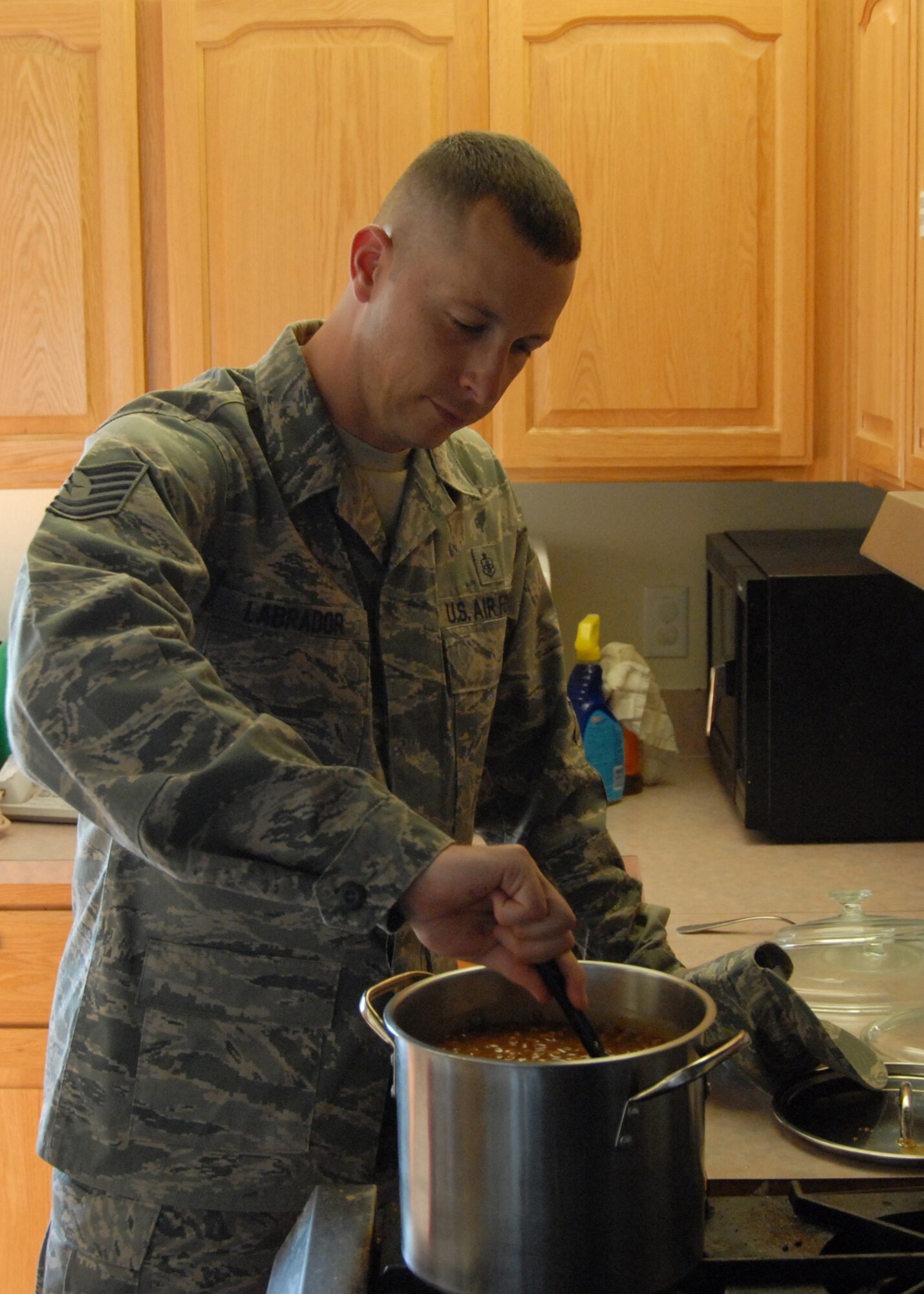 Tech. Sgt. Carlos Labrador, Edwards Middle-Tier Assocation president, prepares food before a Dorm Dwellers Dinner June 17at the Chapel 1 annex here. The dorm dinners are free to all dorm residents from both the Air Force and Marine Corps. (Air Force photo/Airman 1st Class William O'Brien) 