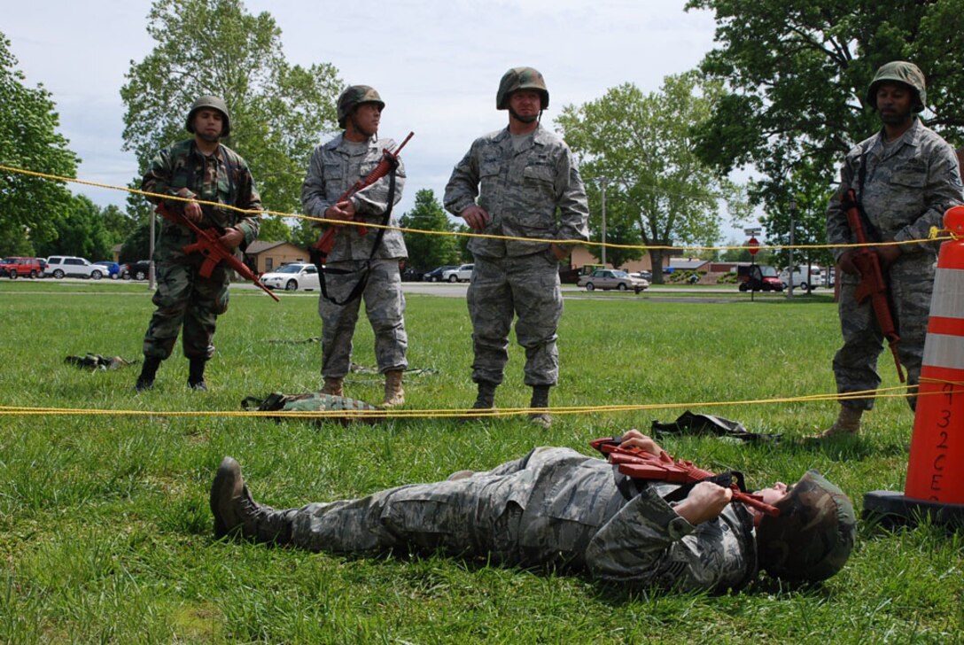 A 932nd Airlift Wing civil engineer with a simulated rifle goes low under an obstacle during recent unit drill training at Scott Air Force Base.  The weekend training was designed to get members ready for future challenges.  (U.S. Air Force photo/Tech. Sgt. Dan Oliver)
