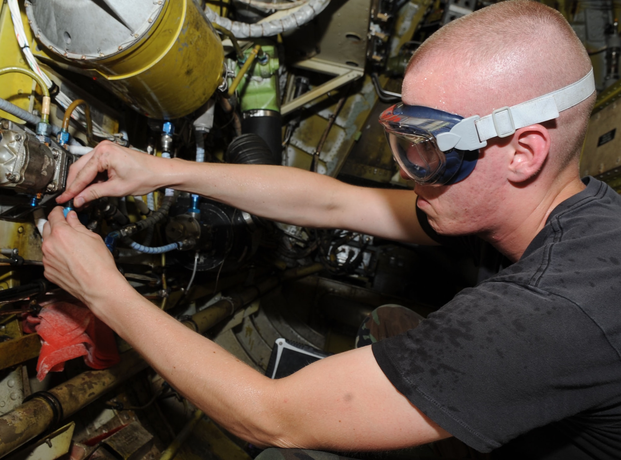 Airman 1st Class Patrick Simmons, 2nd Expeditionary Aircraft Maintenance Unit hydraulics journeyman, changes the rutter elevator hydraulic transformer on a B-52 Stratofortress bomber June 16.   Airman Simmons is deployed here from Barksdale Air Force Base, La. to support U.S. Pacific Command's Continuous Bomber Presence in the Asia-Pacific Region (U.S. Air Force photo/ Christopher Bush)
