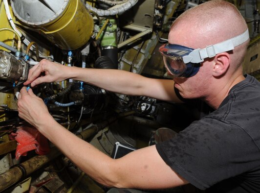 Airman 1st Class Patrick Simmons, 2nd Expeditionary Aircraft Maintenance Unit hydraulics journeyman, changes the rutter elevator hydraulic transformer on a B-52 Stratofortress bomber June 16.   Airman Simmons is deployed here from Barksdale Air Force Base, La. to support U.S. Pacific Command's Continuous Bomber Presence in the Asia-Pacific Region (U.S. Air Force photo/ Christopher Bush)
