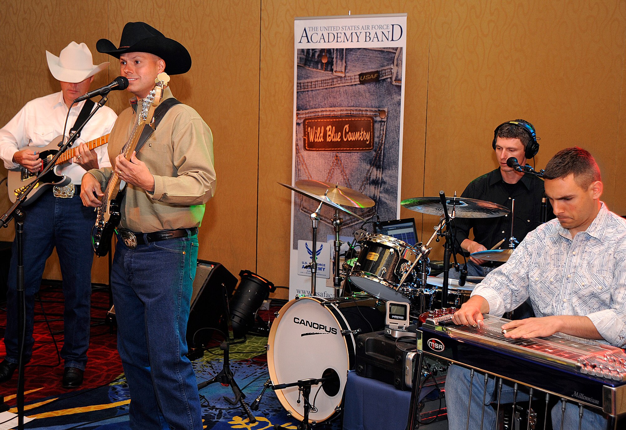 Members of the U.S. Air Force Academy country band 'Wild Blue Country' play for the crowd June 13 during a chief's recognition ceremony at the Crowne Royal Plaza in Colorado Springs, Colo. The ceremony honored each recently-promoted chief master sergeant to their new rank during the joint of both the 310th Space Wing and 302nd Airlift Wing event. Both wings are assigned to the Air Force Reserve. (U.S. Air Force photo/Craig Denton)