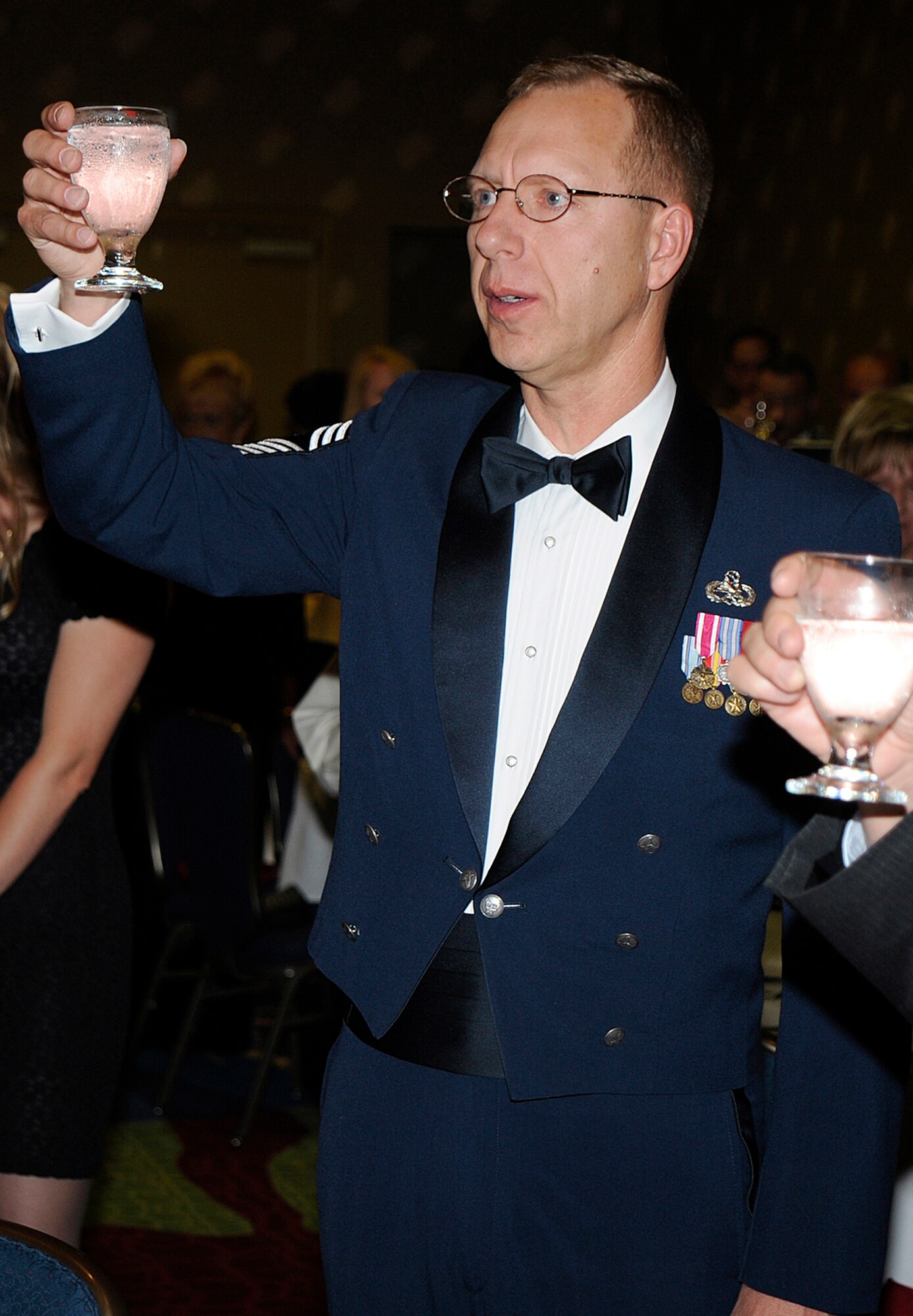 Chief Master Sgt. Joe Westerlund raises his glass in honor of recently-promoted chief master sergeants June 13 during a chief's recognition ceremony at the Crowne Royal Plaza in Colorado Springs, Colo. The ceremony honored each recently-promoted chief master sergeant to their new rank during the joint of both the 310th Space Wing and 302nd Airlift Wing event. Both wings are assigned to the Air Force Reserve. (U.S. Air Force photo/Craig Denton)