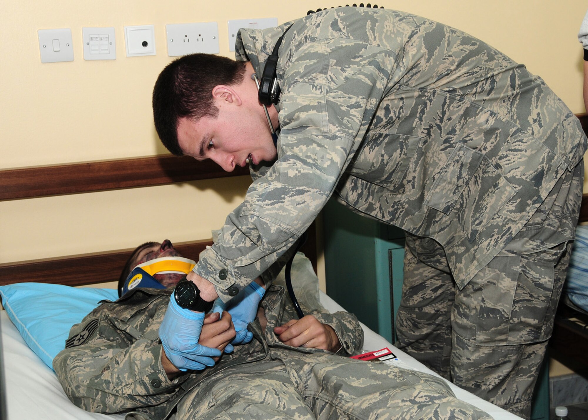 Capt. Donald Euler checks the severity of burns a "patient" received during a dorm fire exercise June 22 at an air base in Southwest Asia. Depending on the degree of severity, a burn victim may experience a wide number of potentially fatal complications including shock, infection, electrolyte imbalance and respiratory distress. Captain Euler is assigned to the 386th Expeditionary Medical Group and deployed from Wright-Patterson Air Force Base, Ohio He is a native of Chattanooga, Tenn. (U.S. Air Force photo/Senior Airman Courtney Richardson)