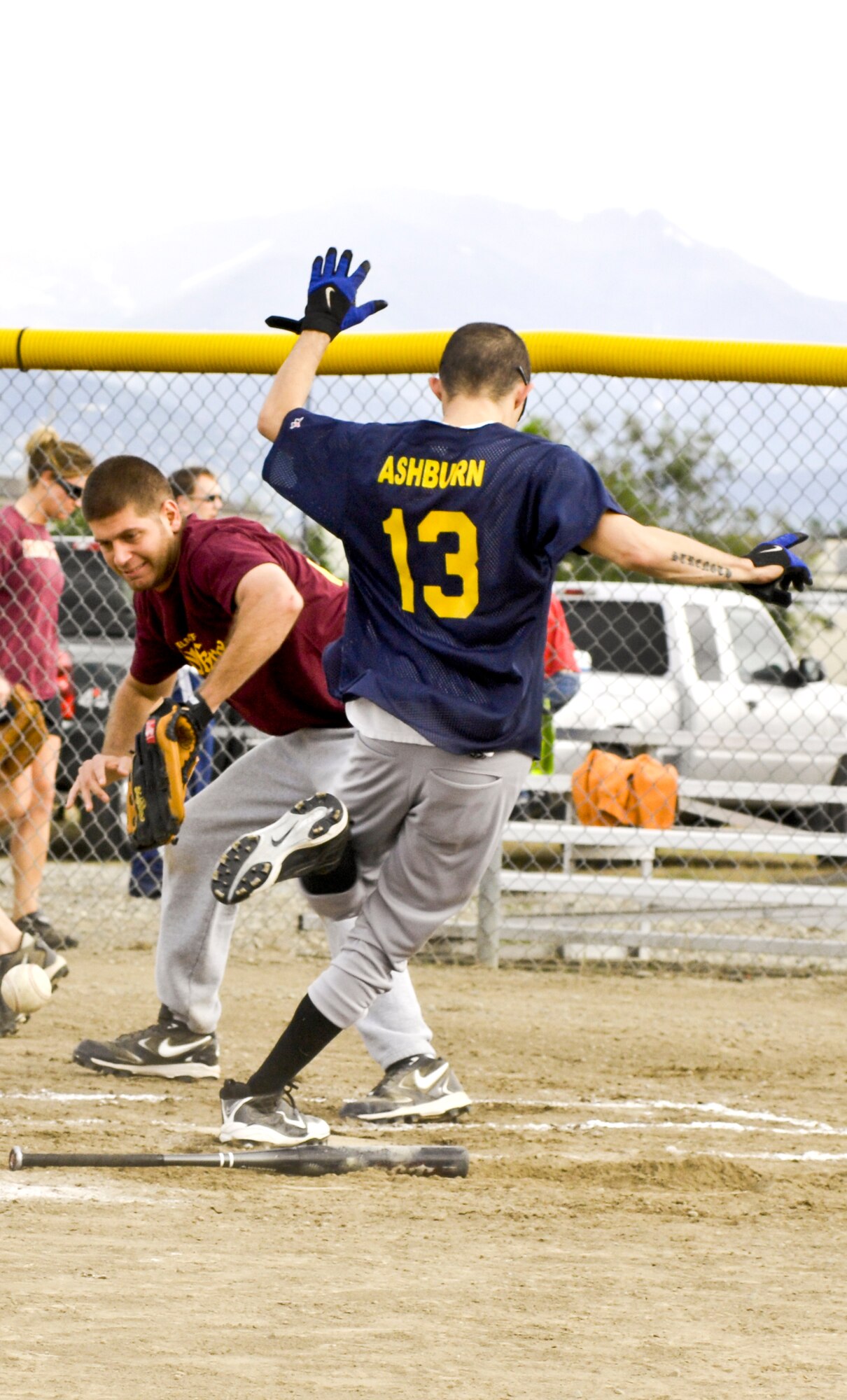 ELMENDORF AIR FORCE BASE, Alaska -- James Ashburn sneaks past catcher Wesley Velez to earn a run for the 3rd Equipment Maintenance Squadron during an intramural softball game June 22. The 3rd Civil Engineer Squadron beat the 3rd EMS team 17-7. Ashburn is a member of the 3rd Equipment Maintenance Squadron and Velez is a member of the 3rd CES. (U.S. Air Force photo/Airman 1st Class Christopher Gross)
