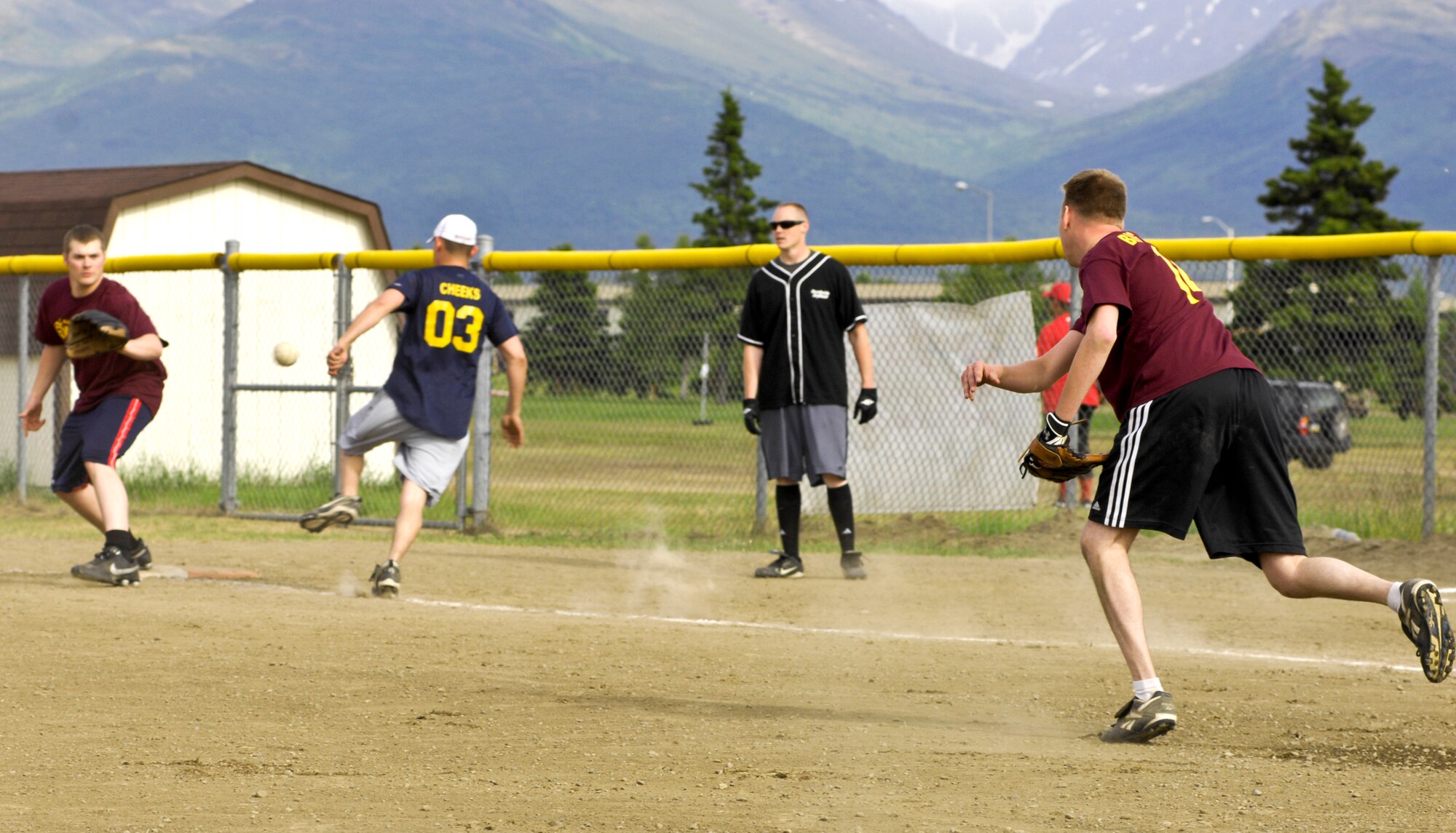 ELMENDORF AIR FORCE BASE, Alaska -- Pitcher Michael Tryon throws to first basemen Michael Craven to make an out during an intramural softball game June 22. The 3rd CES defeated the 3rd Equipment Maintenance Squadron 17-7. Tryon and Craven are members of the 3rd Civil Engineer Squadron. (U.S. Air Force photo/Airman 1st Class Christopher Gross)