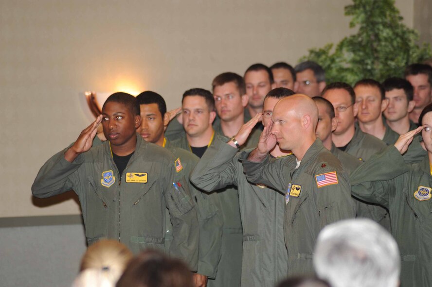 Members of the 906th Air Refueling Squadron render their final salute under the 319th Air Refueling Wing at Grand Forks AFB. A mission complete ceremony for the squadron occured June 19. The squadron will continue its mission from Scott AFB, Ill.  (U.S. Air Force photo/Tech. Sgt. Johnny Saldivar)