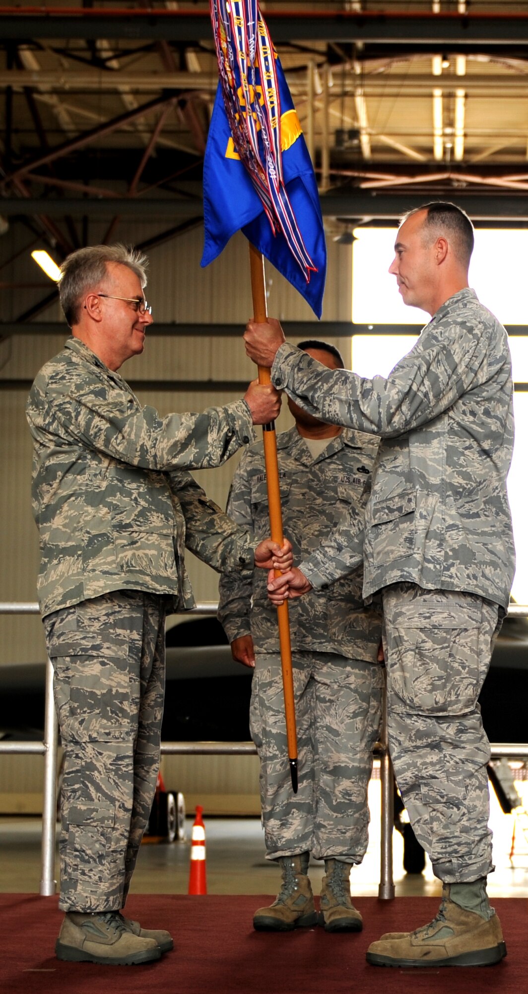 WHITEMAN AIR FORCE BASE, Mo. - Lt. Col. Richard Gibbs receives the 509th Maintenance Squadron guidon June 19 from Col. James Reavis, 509th Maintenance Group commander, during a change of command ceemony. Colonel Gibbs replaces Maj. Chad Heyen as the 509th MXS commander. (U.S. Air Force photo/Airman 1st Class Carlin Leslie)