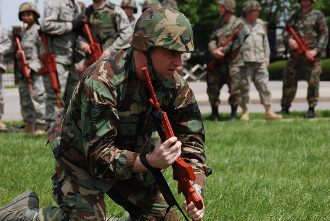 A 932nd Airlift Wing civil engineer hits the deck with a simulated orange rifle during recent unit drill training at Scott Air Force Base, Ill.  (U.S. Air Force photo/Tech. Sgt. Dan Oliver)