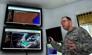 Tech. Sgt. Tommy Dunlap gives a weather brief explaining Doppler Radar and enhanced infrared satellite imagery for the Southeast at the command post building here June 19. Images are received from sensors covering the region and are compiled to produced a large-scale view of weather systems, allowing aircrews to avoid dangerous flight paths. Sergeant Dunlap is the lead forecaster with 437th Operations Support Squadron Weather Flight. (U.S. Air Force photo/Staff Sgt. Daniel Bowles)
