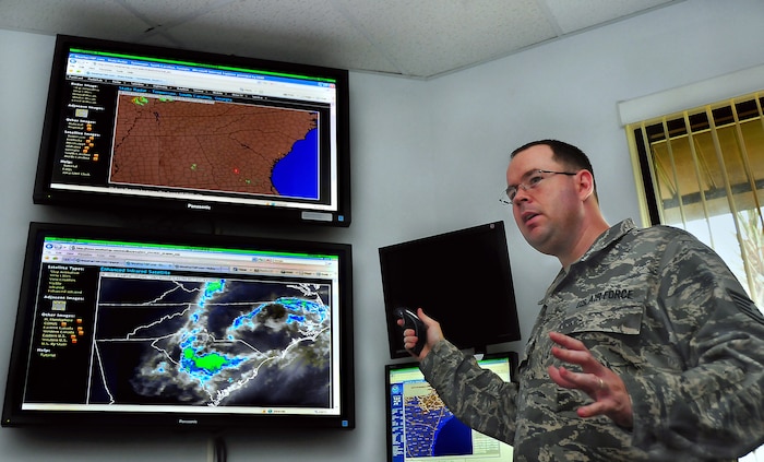 Tech. Sgt. Tommy Dunlap gives a weather brief explaining Doppler Radar and enhanced infrared satellite imagery for the Southeast at the command post building here June 19. Images are received from sensors covering the region and are compiled to produced a large-scale view of weather systems, allowing aircrews to avoid dangerous flight paths. Sergeant Dunlap is the lead forecaster with 437th Operations Support Squadron Weather Flight. (U.S. Air Force photo/Staff Sgt. Daniel Bowles)