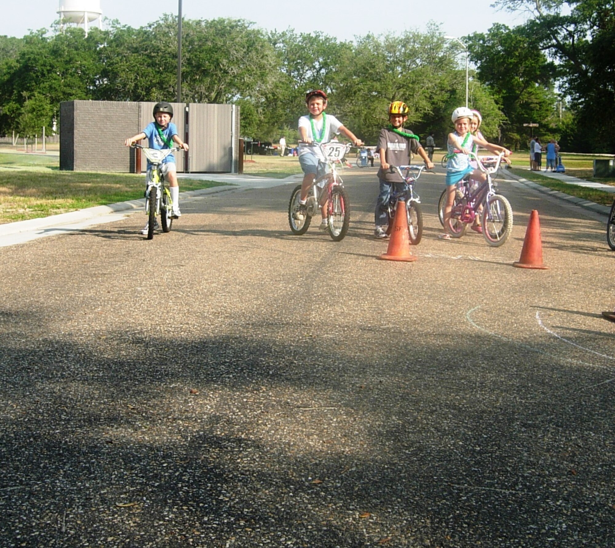 Children ages four to 16 appeared Saturday morning at the Belfour Beatty Community Center in base housing to participate in a bicycle rodeo designed to instruct bicycle safety and techniques.  Speeding through cones and a paper toss were just few of the events that took place.  (U.S. Air Force photo/Airman 1st Class Veronica McMahon)
