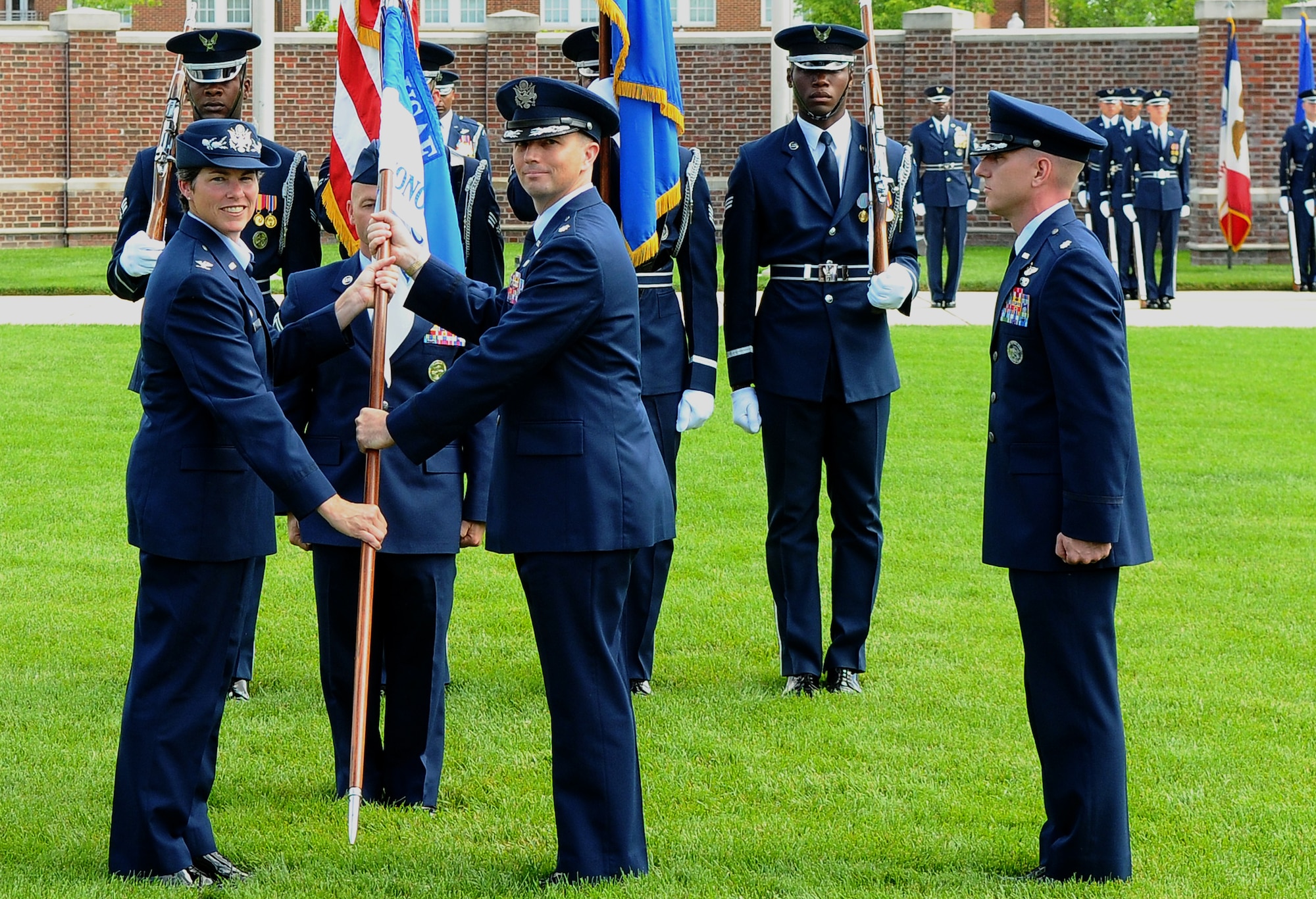 Col. Elizabeth Borelli, 11th Operations Group commander, passes a guidon to Lt. Col. Raymond M. Powell symbolizing his assumption of command of the U.S. Air Force Honor Guard from, during the change-of-command ceremony June 23 on the U.S. Air Force Ceremonial Lawn, Bolling Air Force Base, D.C. These ceremonies represent the formal passing of responsibility, authority and accountability of command from one officer to another. (U.S. Air Force photo by Senior Airman Alex Montes)