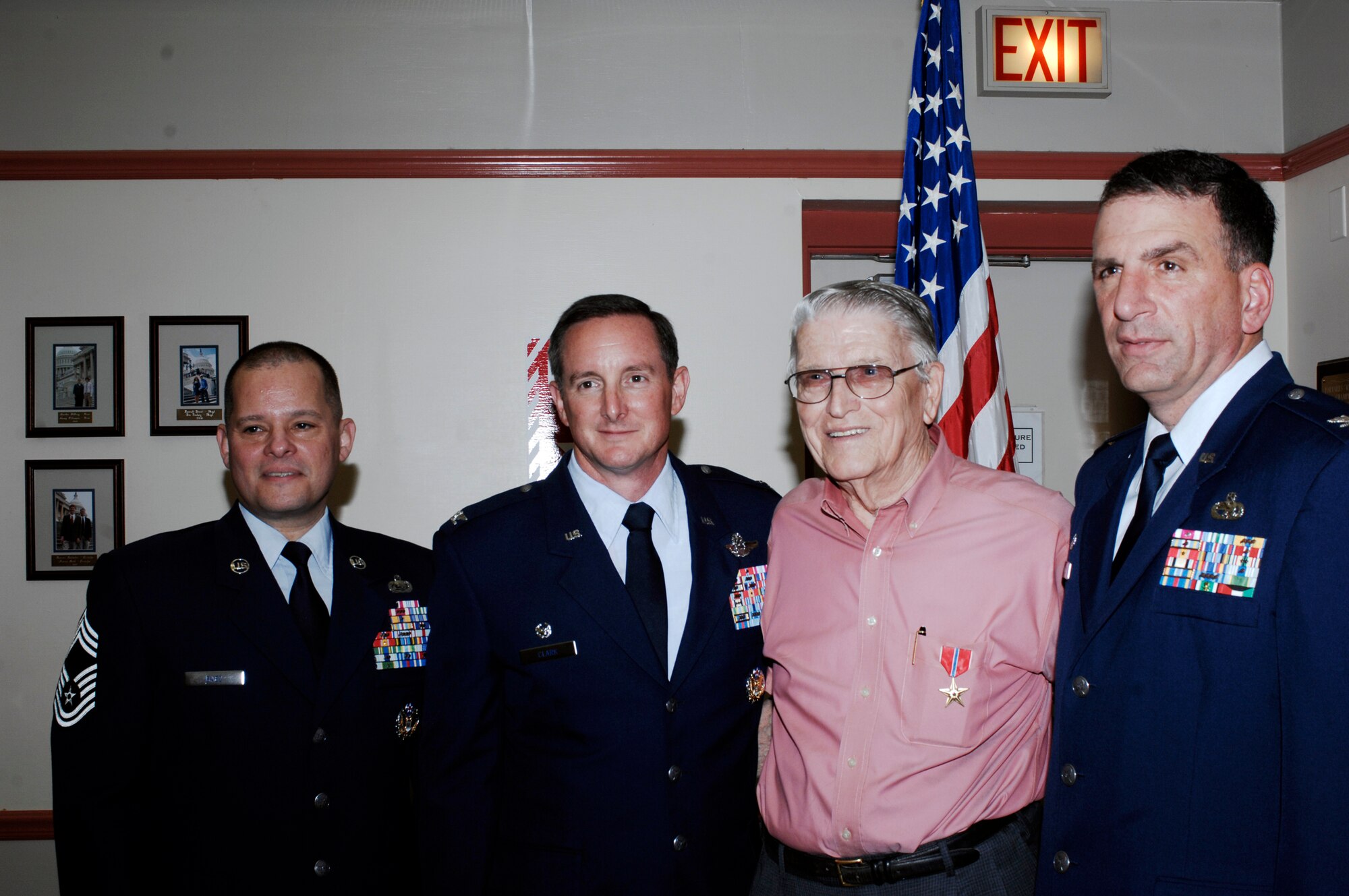 CANNON AIR FORCE BASE, N.M. -- Henry Wallace, a rifleman during World War II, is flanked by 27th Special Operations Wing leadership, following the presentation of the Bronze Star Medal to Mr. Wallace June 21 in Portales, N.M. From left to right are Chief Master Sgt. Hector Baez, 27th Special Operations Mission Support Group superintendent, Col. Stephen Clark, 27th Special Operations Wing commander, Mr. Wallace and  Col. Mark LaRose, 27th Special Operations Maintenance Group commander. (U.S. Air Force photo by Greg Allen) 
