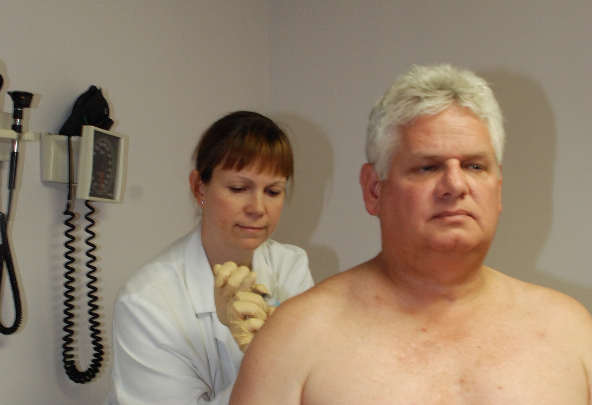 Retired Navy Robert Decent, 47, receives a cortisone shot from Capt. (Dr.) Michelle Jurkonie, a resident with the 779th Medical Operations Squadron Family Practice Residency Program on Andrews Air Force Base, Md. As a resident, Captain Jurkonie maintains a caseload of hundreds of patients.