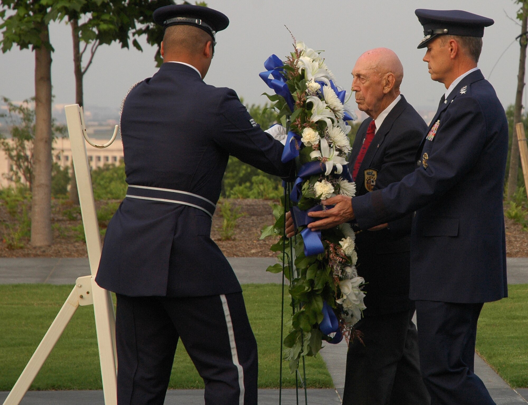 Gen. William M. Fraser III, U.S. Air Force vice chief of staff, and surviving Doolittle Raider Richard Cole are assisted by a United States Air Force Honor Guard member during a wreath-laying ceremony June 19 at the U.S. Air Force Memorial in Arlington, Va. The wreath was laid near the Missing Man Wall to honor Maj. Gen. David Jones, a former Doolittle Raider and prisoner of war, who was buried at Arlington National Cemetery earlier that day. (U.S. Air Force photo by Senior Airman R. Michael Longoria)