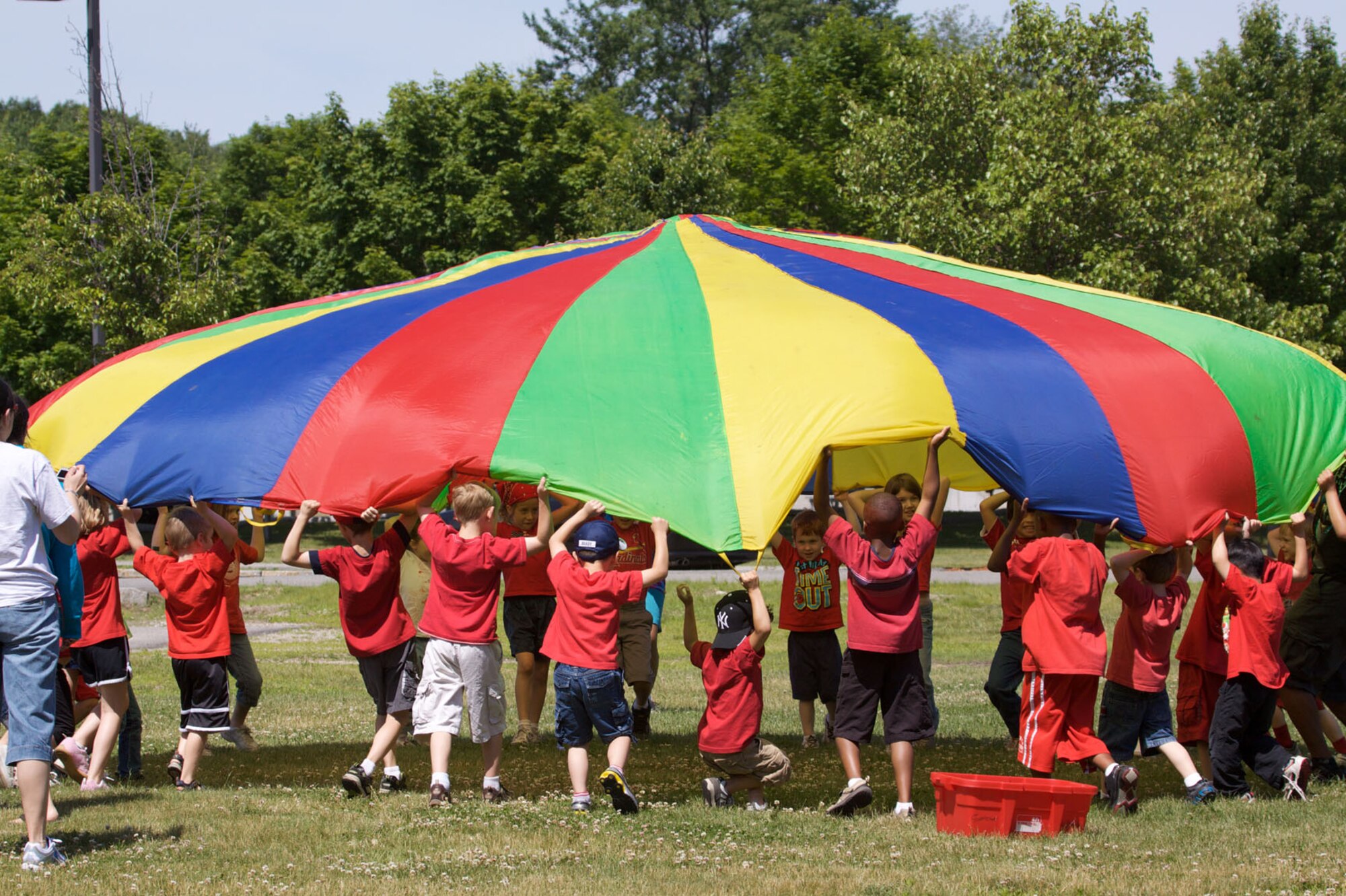 HANSCOM AIR FORCE BASE, Mass. –Hanscom Primary School students enjoy a parachute activity during their field day event on June 17. (Photo by Lt. Col. Loralee Manas)