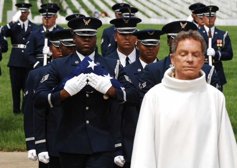 The United States Air Force Honor Guard carries the American flag preceding the ashes of Maj. Gen. David M. Jones during his funeral June 19 at Arlington National Cemetery, Va. The general served more than 40 years in the military, most notably as a member of the Doolittle Raiders and two and a half years as a prisoner of war. He was 94 years old when he passed away of heart failure at his home in Tucson, Ariz. Nov. 25, 2008. His military decorations and awards include the Legion of Merit, Distinguished Flying Cross with oak leaf cluster, Air Medal, Air Force Commendation Medal with oak leaf cluster, Purple Heart, Yum Hwei from the Chinese Government, the NASA Exceptional Service Medal with device, and the NASA Distinguished Service Medal. (U.S. Air Force photo by Senior Airman Alex Montes)