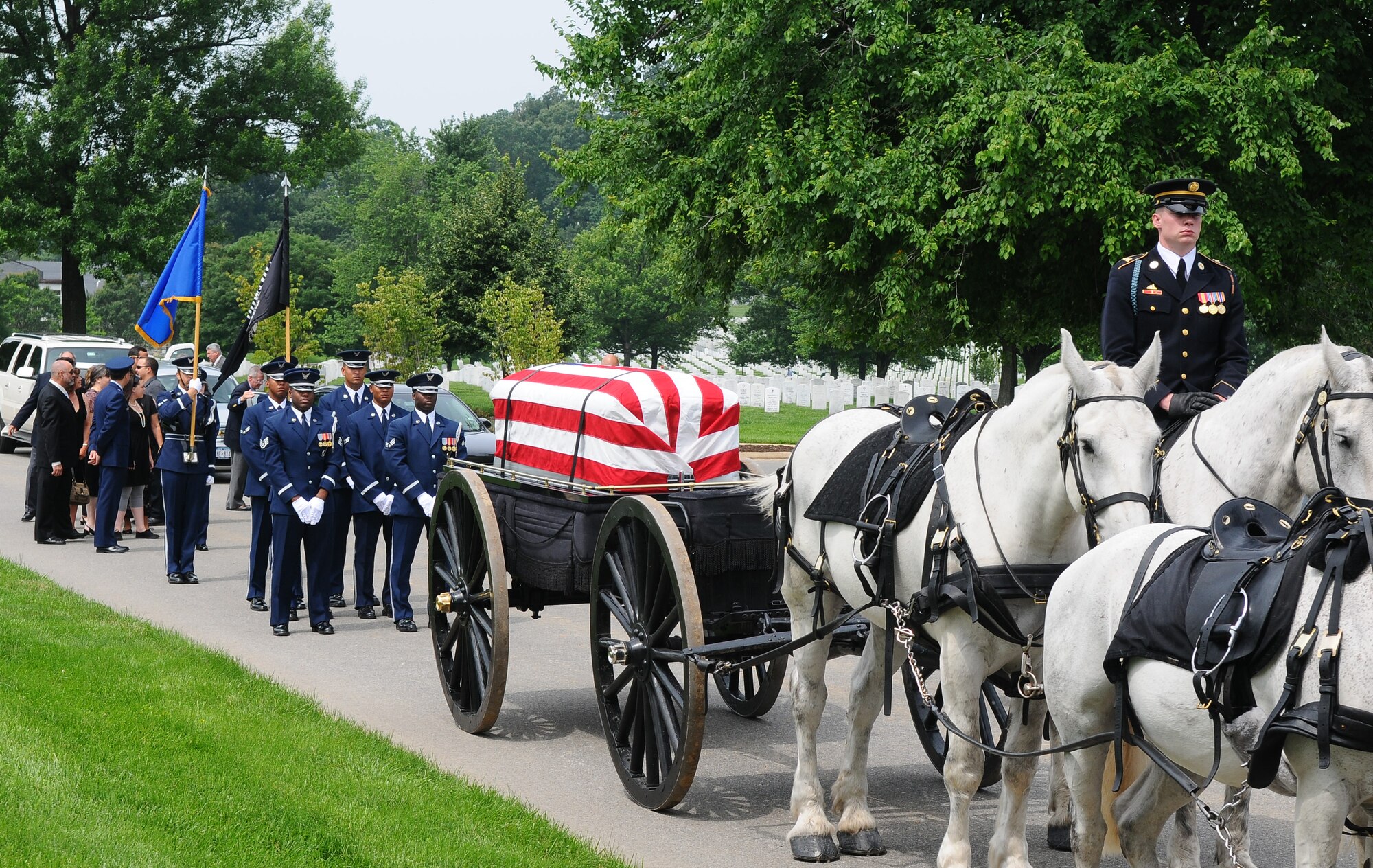 The United States Air Force Honor Guard marches in a procession to honor one of the famous ‘Doolittle Raiders’ during his funeral  June 19 at Arlington National Cemetery, Va. Maj. Gen. David M. Jones originally enlisted in the National Guard in June 1932 and retired June 1973 but continued to serve after his enlistment until his death in November 2008. In early 1942, General Jones volunteered to fly some of the initial B-52 flights as part of the Doolittle Project. General Jones also spent two and a half years as a prisoner of war in Stalag Luft III after being shot down over Bizerte, North Africa. After his liberation in April 1945, General Jones was commended for leadership among his fellow prisoners. His military decorations and awards include the Legion of Merit, Distinguished Flying Cross with oak leaf cluster, Air Medal, Air Force Commendation Medal with oak leaf cluster, Purple Heart, Yum Hwei from the Chinese Government, the NASA Exceptional Service Medal with device, and the NASA Distinguished Service Medal. (U.S. Air Force photo by Senior Airman Alex Montes)
