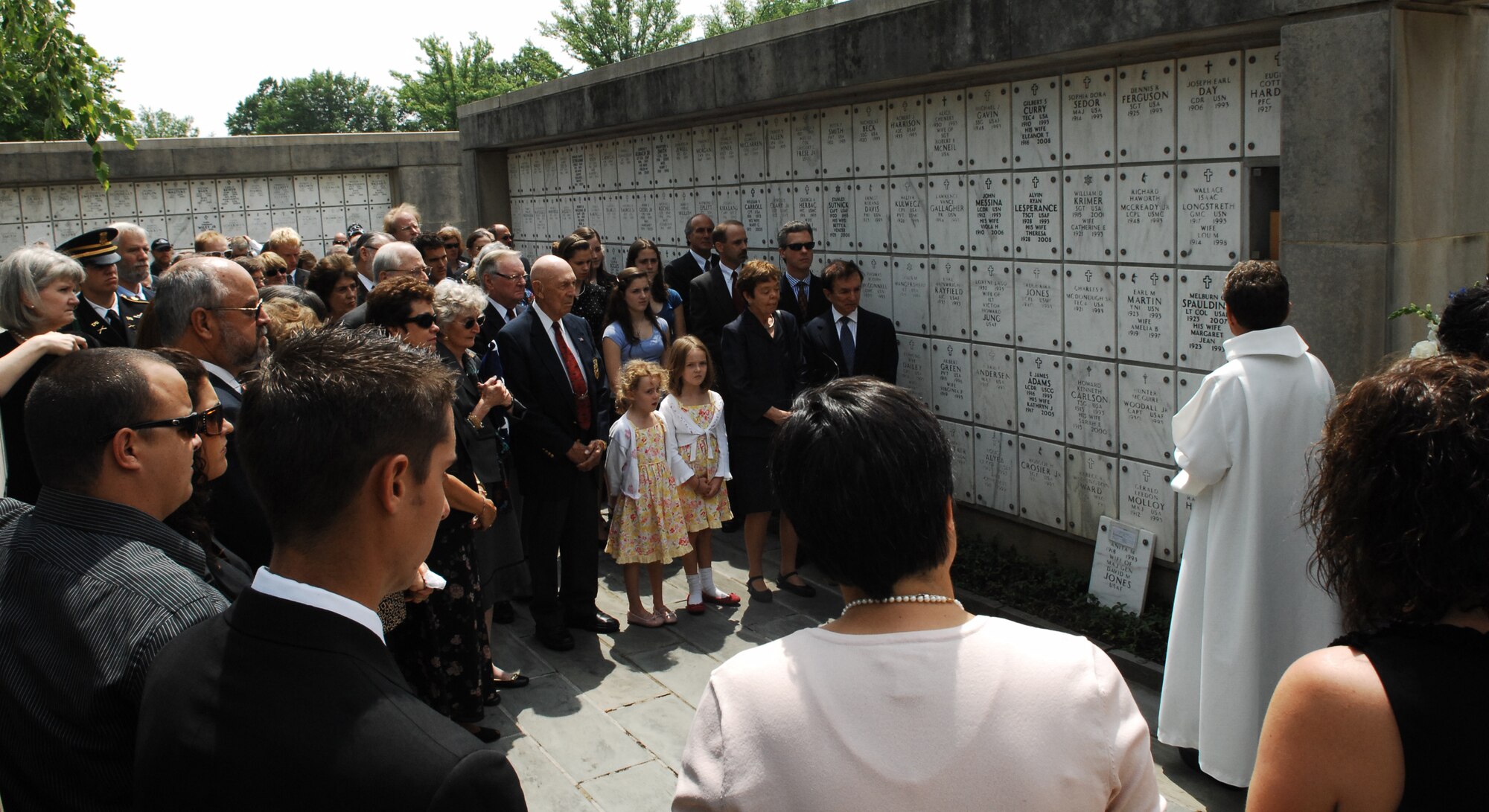 Family members and friends pay their respect to Maj. Gen. David M. Jones, one of the historic Doolittle Raiders, during a full-honors funeral June 19 at Arlington National Cemetery, Va. The general served more than 40 years in the military but was most recognized for his actions from 1942 when he volunteered for the Doolittle Project. During the training phase of this project, he flew the initial evaluation flights on B-25 aircraft specially equipped for the mission. After the Doolittle raid on Tokyo, he bailed out over China. The Chinese people assisted him in returning to the United States. He received the Distinguished Flying Cross for his participation as a flight commander in the planning, training and completion of the Doolittle raid on Tokyo. (U.S. Air Force photo by Senior Airman Alex Montes)
