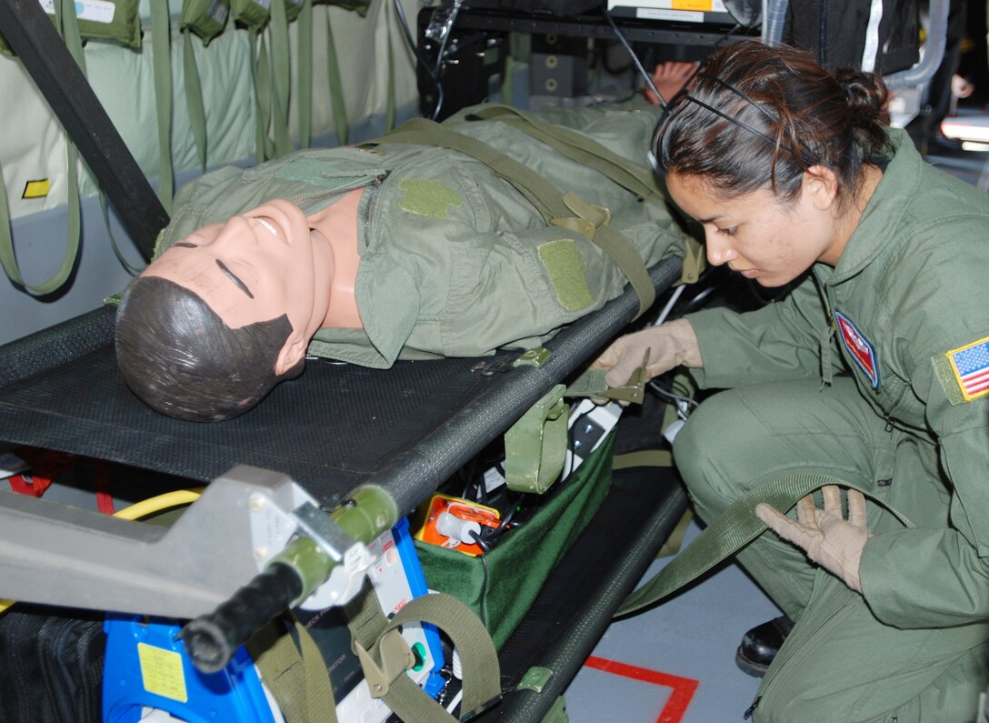 Senior Airman Erika Akamine checks aeromedical equipment during an exercise in a modified KC-135 Stratotanker June 18 at Scott Air Force Base, Ill. Airman Akamine is assigned to the 375th Aeromedical Evacuation Squadron. (U.S. Air Force photo) 