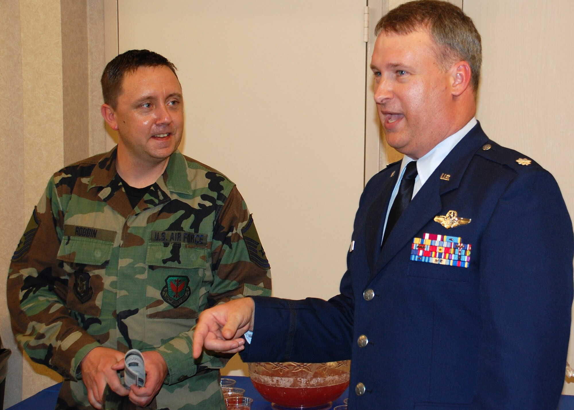 Lt. Col. Steven Foss, 302nd Operations Support Flight commander (right), chats with Master Sgt. David Robbin and other members of his flight June 14 after an assumption of command ceremony at the Peterson Air Force Base theater in southern Colorado. Colonel Foss takes command of the flight from Lt. Col. Tom Henderson. (U.S. Air Force photo/Tech. Sgt. Daniel Butterfield)