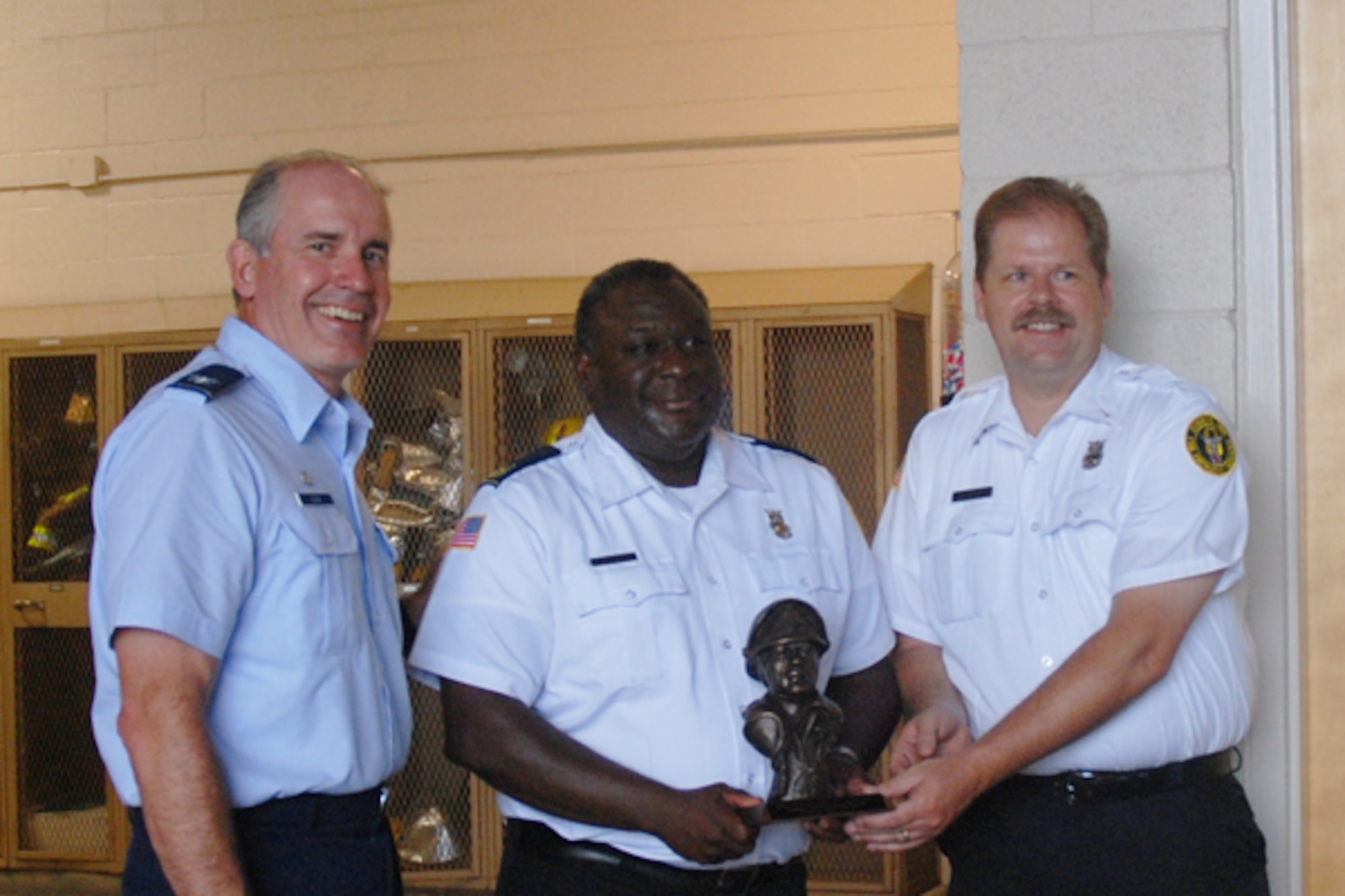 Col. Steven H. Slick, 94th Mission Support Group commander presents the Air Force Reserve Command 2008 Fire Prevention Program Award to William L. Wilson, assistant chief of Fire Prevention and Mark A. Berkenmeier, fire inspector. (U.S. Air Force photo/Kennith Green)