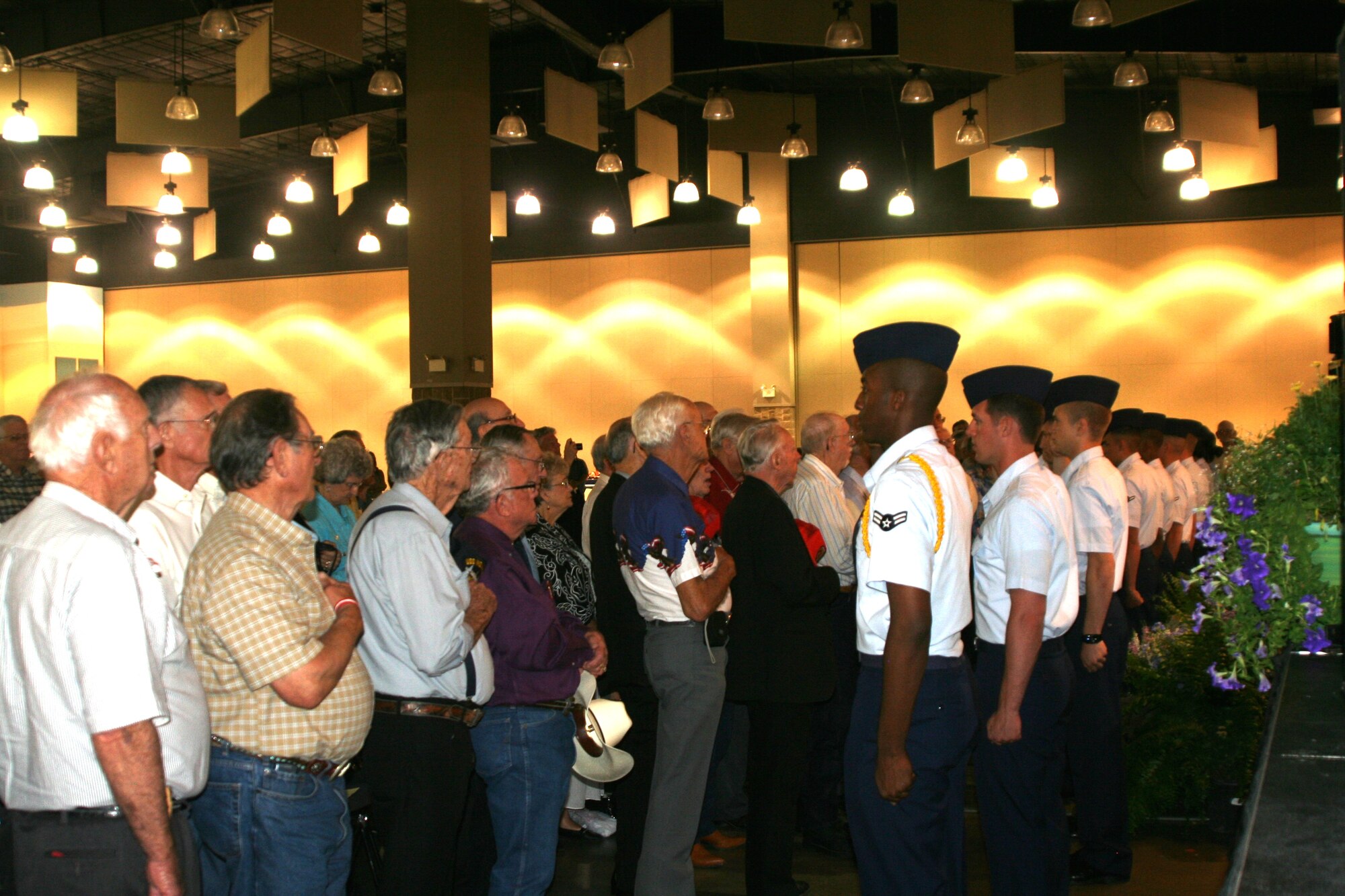 Airmen in Training and more than 100 veterans pay tribute to the flag June 20 at the 22nd Annual Legends of Western Swing Music Festival at the Multi-purpose Events Center in Wichita Falls.  Eddy McAlvain and the Mavericks kicked off the event with “There’s A Star Spangled Banner Waving Somewhere”. (U.S. Air Force photo/ Master Sgt. John Myers)
