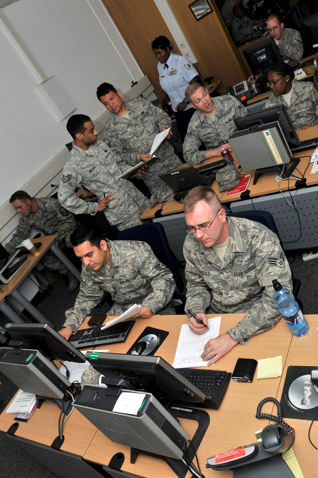 Airmen from both the 435th Communications Squadron and the Air Force Reserve's 302nd Communications flight work hand in hand June 8 maintaining computer system hardware for Ramstein Air Base in Germany. The reservists are part of a group of 20 Airmen performing two weeks of annual tour duty in support of Ramstein's communication mission. Many active duty Airmen in the communications career field at the air base have been forward deployed to Iraq and Afghanistan in support Operations Iraqi and Enduring Freedom. (U.S. Air Force photo/Staff Sgt. Stephen J. Otero)