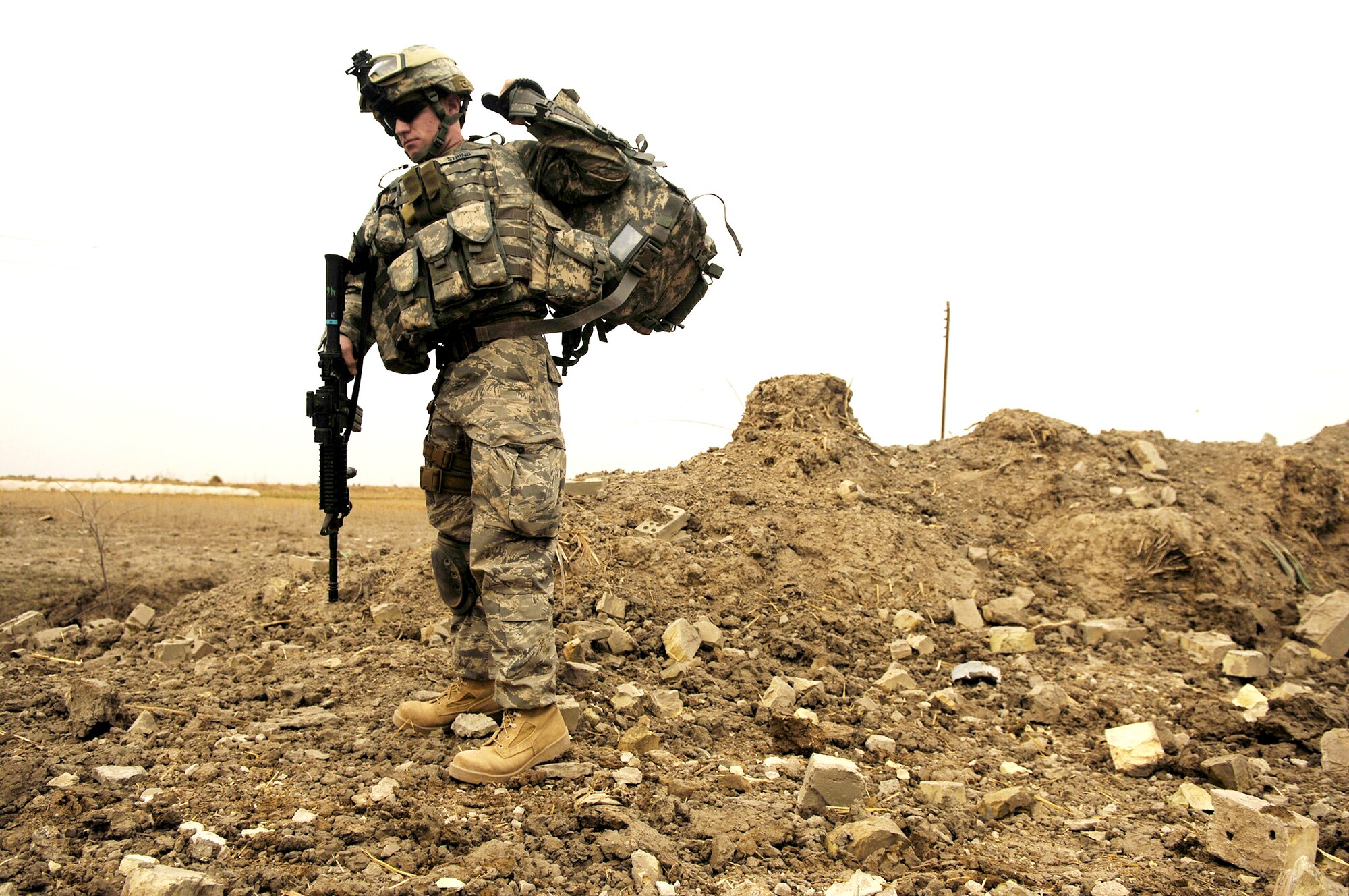 Airman 1st Class Daniel String puts his radio and gear on after a B-1B Lancer successfully dropped six GBU-38 munitions onto an al-Qaida torture house and prison in 2008 in northern Zambraniyah, Iraq. Airman String is a joint terminal attack controller. (U.S. Air Force photo/Master Sgt. Andy Dunaway)