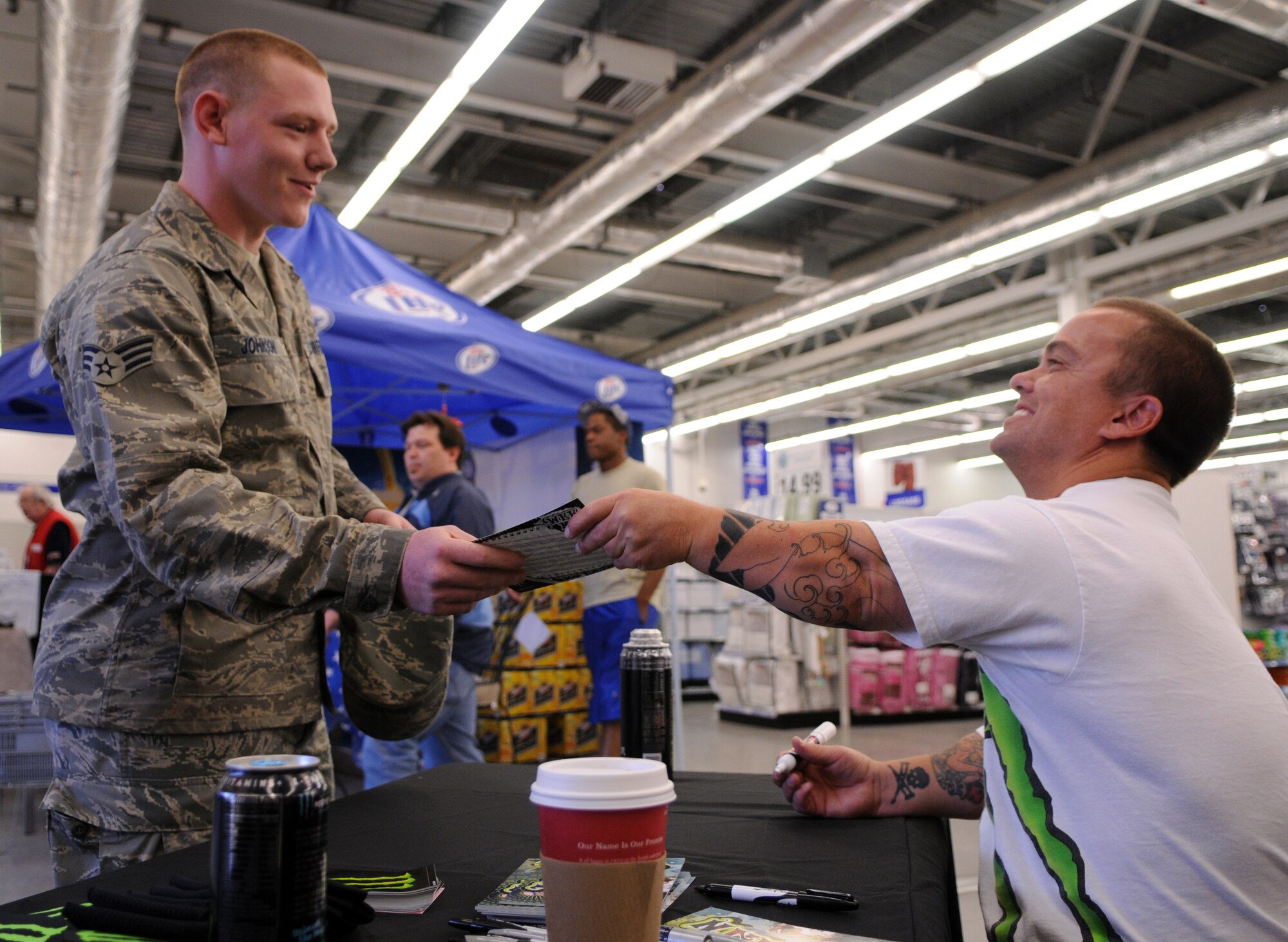 Senior Airman Steven Johnson, RAF Mildenhall postal clerk, gets an autograph from professional skateboarder Jason "Wee Man" Acuna at the Base Exchange June 23.  Wee Man stopped at the base on a tour of military installations throughout Europe sponsored by Monster Energy Drinks.  The celebrity spokesman said he appreciates the members of the Armed Forces, thanking them for what they do and allowing him "to sit at home and do what he does."  (U.S. Air Force photo by Staff Sgt. Austin M. May/No federal endorsement intended/implied.)