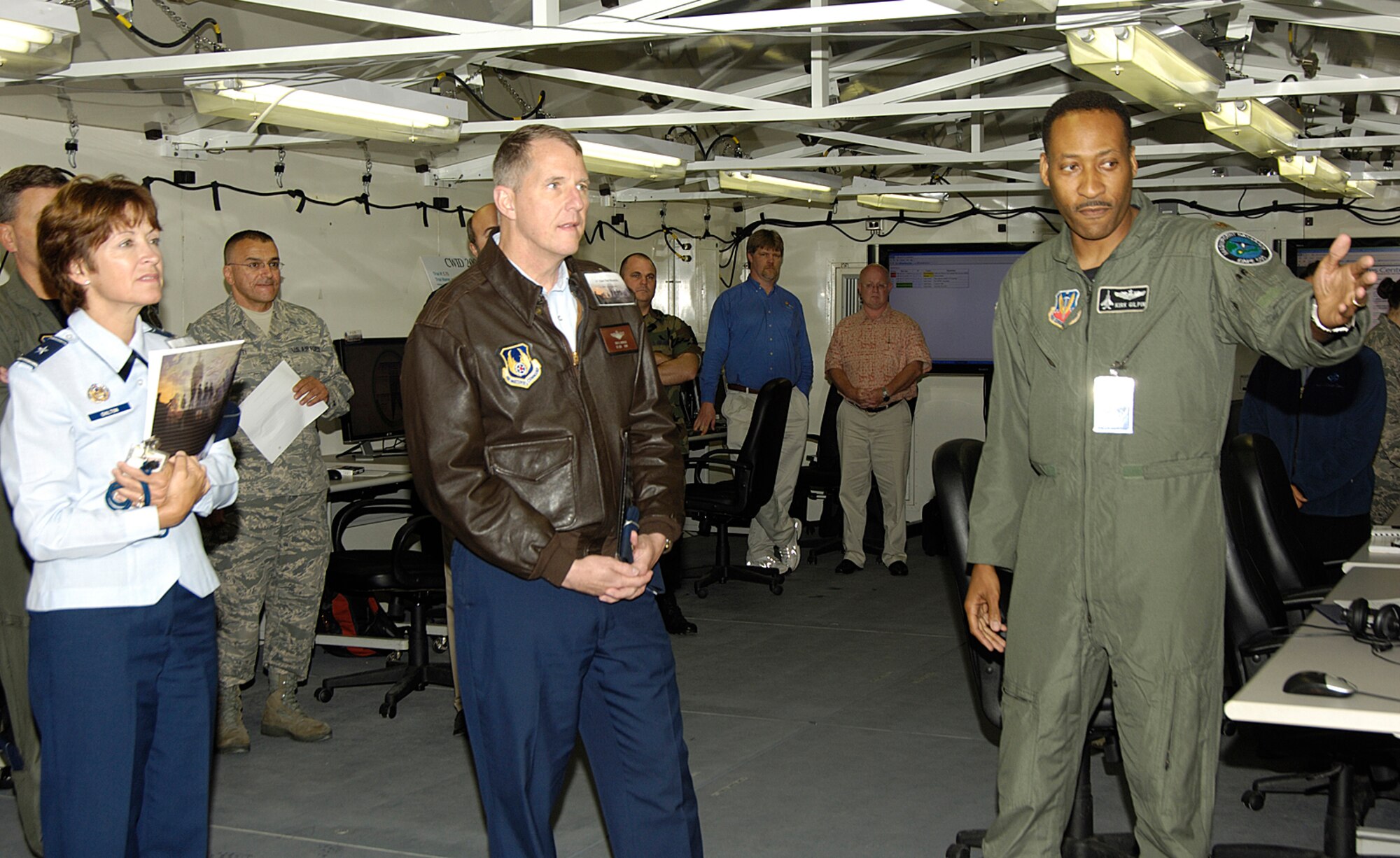 HANSCOM AIR FORCE BASE, Mass. -- Mass. Air National Guard Maj. Kirk Gilpin briefs Electronic Systems Center Commander Lt. Gen. Ted Bowlds and his Individual Mobilization Augmentee, Brig. Gen. Cathy Chilton, June 22.  The generals viewed ongoing Coalition Warrior Interoperability Demonstration (CWID) activities here.  Hanscom is the lead Air Force site for CWID, a global event that identifies and assesses technical solutions to warfighting capability gaps.  (USAF Photo/Linda LaBonte-Britt)