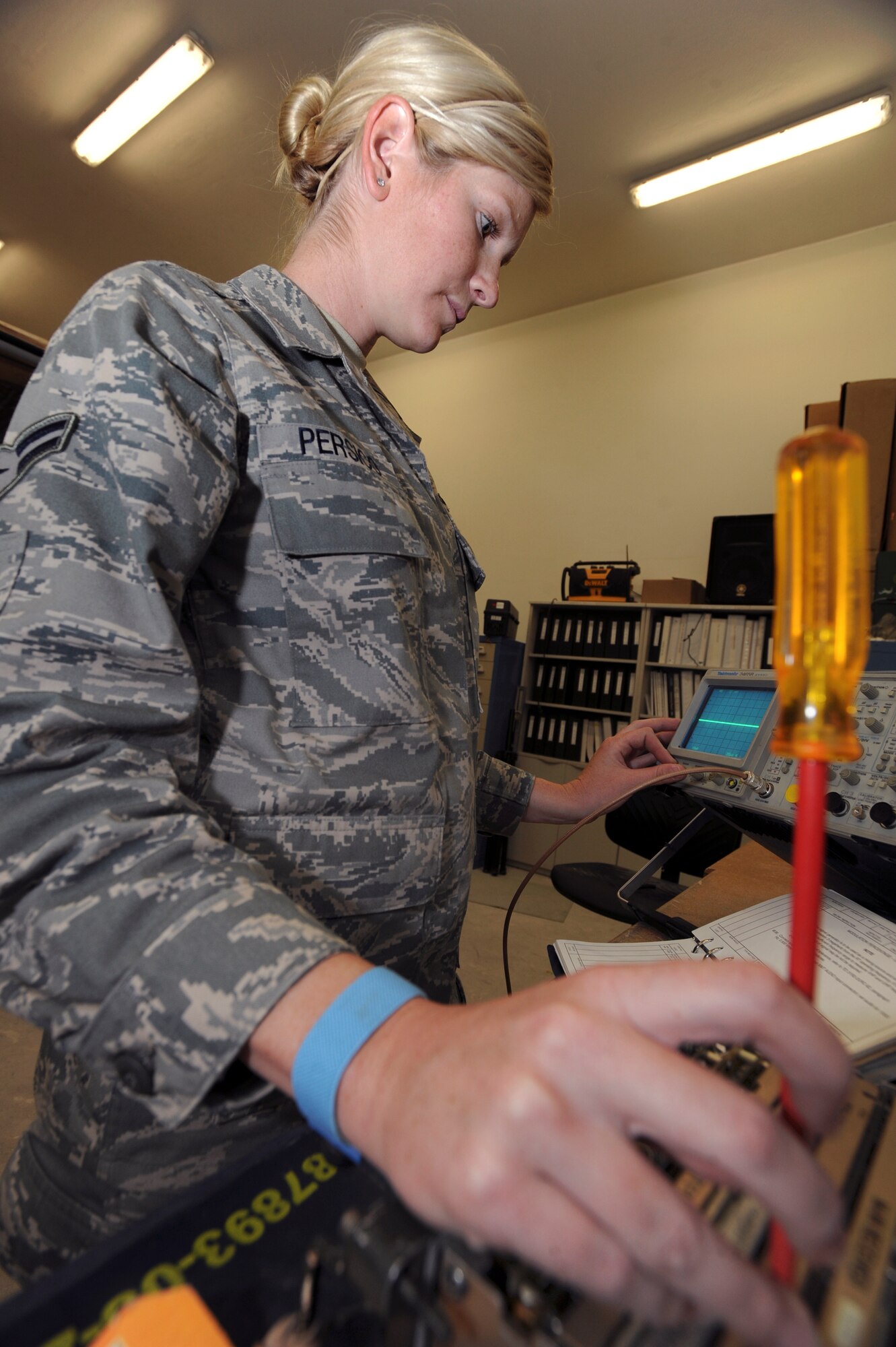 Airmen 1st Class Lauren Persico, a ground radio maintainer with the 379th Expeditionary Communications Squadron, uses an oscilloscope to adjust the modulation on a RT-1319B ground to air radio, June 22, 2009, in an undisclosed location in Southwest Asia.  The percent of modulation needs to be at a certain frequency so the clarity of the radio is good for mission use. Airman Persico is native to Sarasota, Fla. and is deployed from Kadena Air Base, Japan in support of Operations Iraqi and Enduring Freedom and Combined Joint Task Force - Horn of Africa.  (U.S. Air Force Photo by Staff Sgt. Joshua Garcia/released)