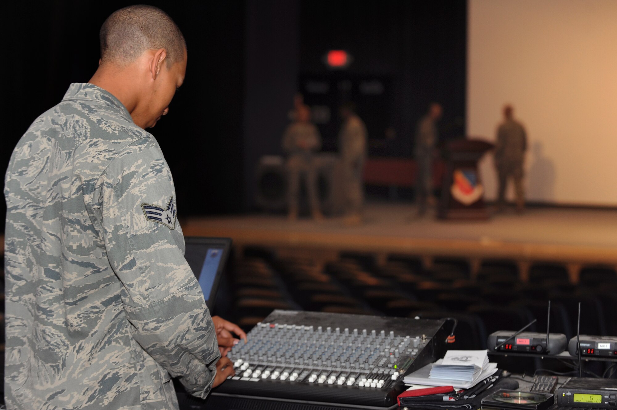 Senior Airman Christopher Twitty, a ground radio maintainer with the 379th Expeditionary Communications Squadron, adjusts the audio levels on a mixer board during a rehearsal for a change of command, 22 June, 2009, in an undisclosed location in Southwest Asia.  Airman Twitty and fellow ground radio maintainers control the audio systems for all ceremonies and events that happen on base.  Airman Twitty is native to Waldarf, Md. and is deployed from Seymour Johnson Air Force Base, N.C., in support of Operations Iraqi and Enduring Freedom and Combined Joint Task Force - Horn of Africa.  (U.S. Air Force Photo by Staff Sgt. Joshua Garcia/released)