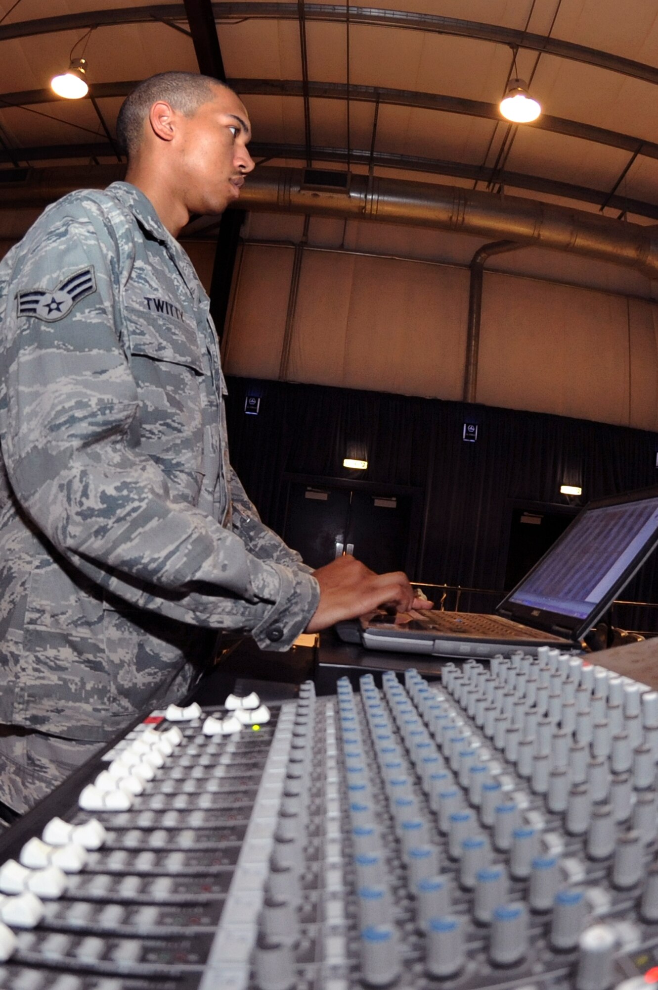 Senior Airman Christopher Twitty, a ground radio maintainer with the 379th Expeditionary Communications Squadron, monitors the volume levels during the rehearsal for a change of command, 22 June, 2009, in an undisclosed location in Southwest Asia.  Airman Twitty and fellow ground radio maintainers control the audio systems for all ceremonies and events that happen on base.  Airman Twitty is native to Waldarf, Md. and is deployed from Seymour Johnson Air Force Base, N.C., in support of Operations Iraqi and Enduring Freedom and Combined Joint Task Force - Horn of Africa.  (U.S. Air Force Photo by Staff Sgt. Joshua Garcia/released)