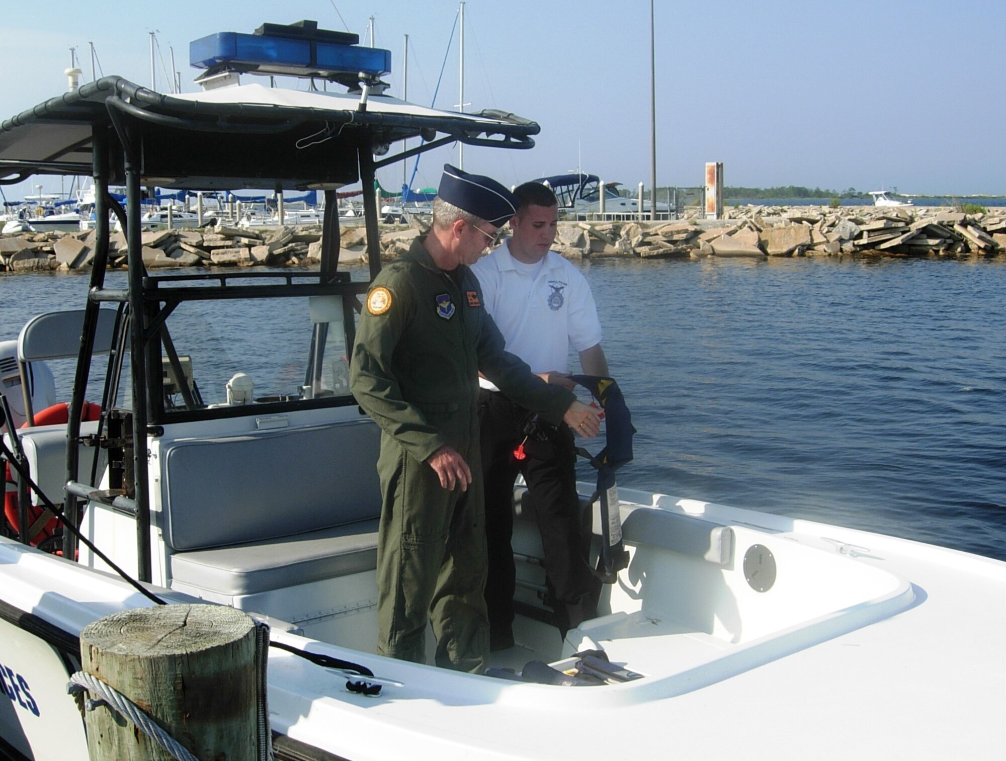 Senior Airman Ryan Regan, 325th Security Forces Squadron patrolman, demonstrates his daily duties to Brig. Gen. Darryl Roberson, 325th Fighter Wing commander, June 19 here.  Airman Regan, selected for the Commander’s Shadow Program, leads a three person community policing team on base housing.  Serving in the Air Force for three years, Airman Regan hails from Rochester, N.Y.  (U.S. Air Force photo/Airman 1st Class Veronica McMahon) 