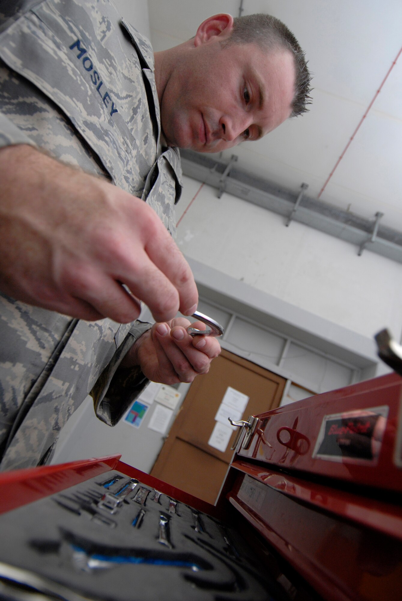 Staff Sgt. Christopher Mosley, 379th Expeditionary Maintenance Squadron aircrew egress systems section chief, gets the tools he will need to check the seat carrier retract thrusters during his inspection on the ejection seat of a B1-B Lancer, June 18, 2009, at an undisclosed location in Southwest Asia.  The seat retract thruster is a system that will reposition the seat during an ejection.  The ejection system is inspected to ensure the pilots can safely eject out the aircraft in an emergency where the plane is in a terminal condition.  The system can launch a 300 lb. individual 200 feet in the air and deploy a parachute in 1.8 seconds.  Sergeant Mosley hails from Savannah, Ga. and is deployed from Dyess Air Force Base, Texas, in support of Operations Iraqi and Enduring Freedom and Combined Joint Task Force - Horn of Africa.  (U.S. Air Force photo/Senior Airman Andrew Satran/released)