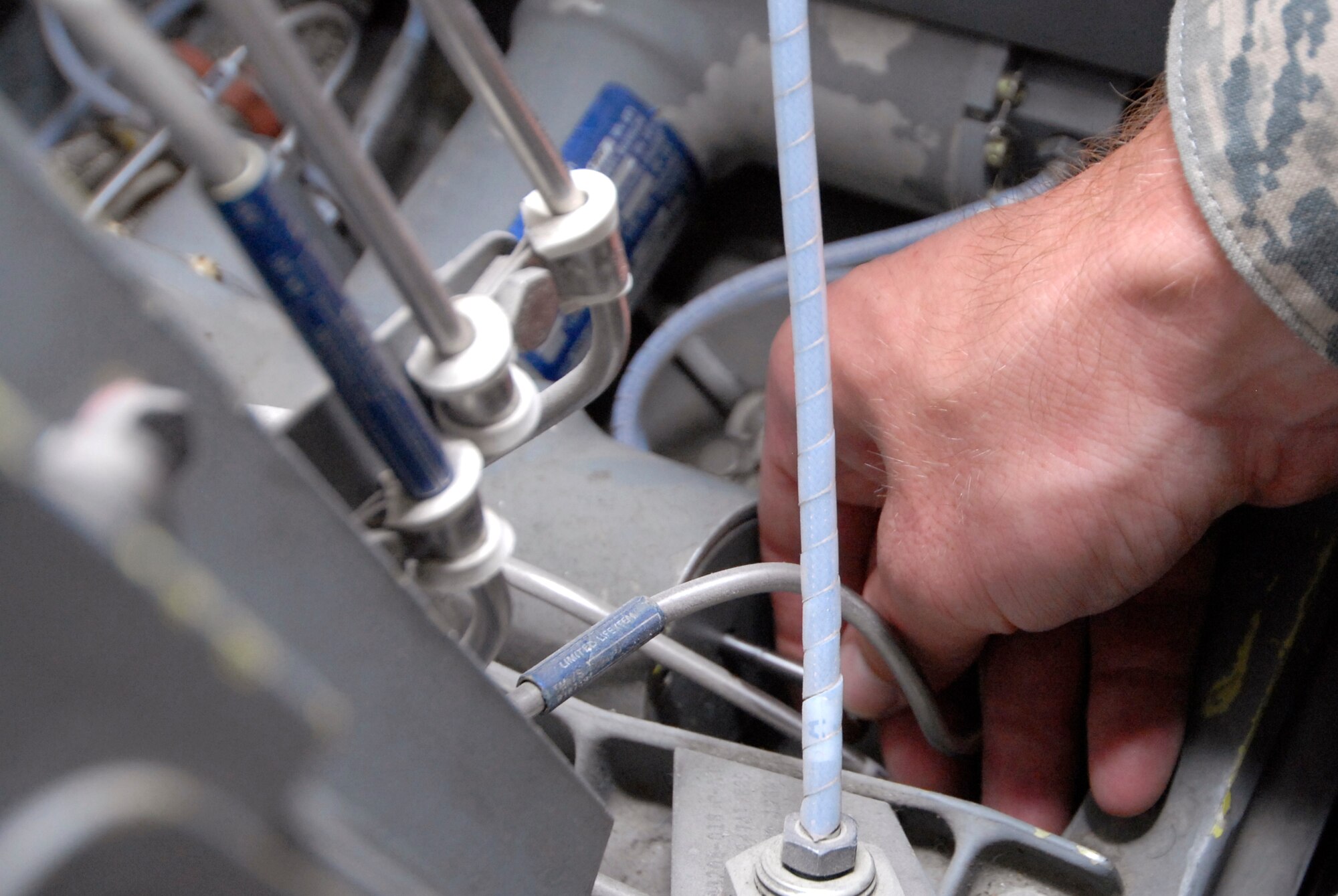 Senior Airman Zachary Davis, a 379th Expeditionary Maintenance Squadron aircrew egress systems journeyman, uses a pre-measured bolt to check the bellows depth for the seat carrier retract thrusters during his inspection on the ejection seat of a B1-B Lancer, June 18, 2009, at an undisclosed location in Southwest Asia.  The seat retract thruster is a system that will reposition the seat during an ejection.  The ejection system is inspected to ensure the pilots can safely eject out the aircraft in an emergency where the plane is in a terminal condition.  The system can launch a 300 lb. individual 200 feet in the air and deploy a parachute in 1.8 seconds.  Airman Davis hails from San Andreas, Calif. and is deployed from Dyess Air Force Base, Texas, in support of Operations Iraqi and Enduring Freedom and Combined Joint Task Force - Horn of Africa.  (U.S. Air Force photo/Senior Airman Andrew Satran/released)