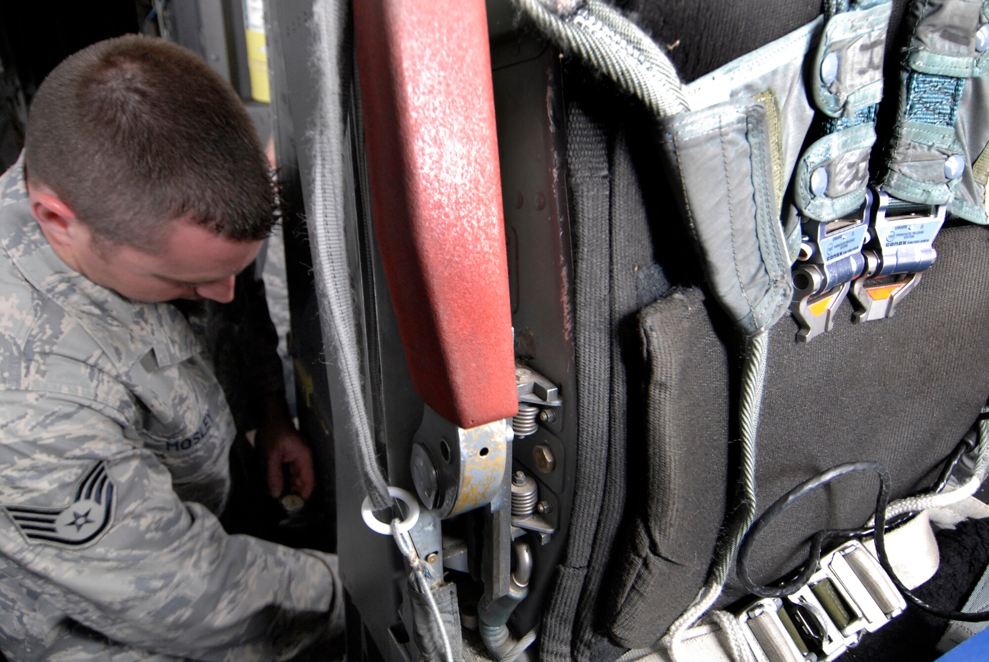 Staff Sgt. Christopher Mosley, 379th Expeditionary Maintenance Squadron aircrew egress systems section chief, inspects the seat carrier retract thrusters during his inspection on the ejection seat of a B1-B Lancer, June 18, 2009, at an undisclosed location in Southwest Asia.  The seat retract thruster is a system that will reposition the seat during an ejection.  The ejection system is inspected to ensure the pilots can safely eject out the aircraft in an emergency where the plane is in a terminal condition.  The system can launch a 300 lb. individual 200 feet in the air and deploy a parachute in 1.8 seconds.  Sergeant Mosley hails from Savannah, Ga. and is deployed from Dyess Air Force Base, Texas, in support of Operations Iraqi and Enduring Freedom and Combined Joint Task Force - Horn of Africa.  (U.S. Air Force photo/Senior Airman Andrew Satran/released)
