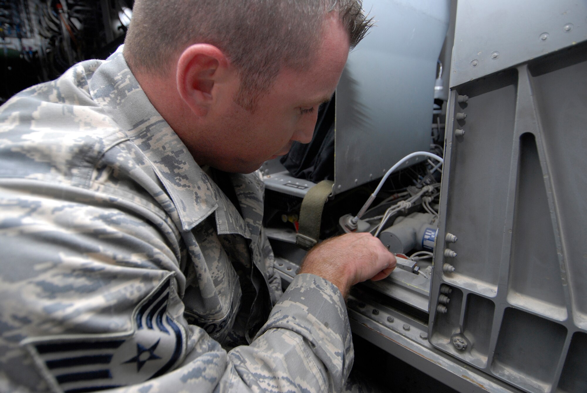 Staff Sgt. Christopher Mosley, 379th Expeditionary Maintenance Squadron aircrew egress systems section chief, inspects the seat carrier retract thrusters during his inspection on the ejection seat of a B1-B Lancer, June 18, 2009, at an undisclosed location in Southwest Asia.  The seat retract thruster is a system that will reposition the seat during an ejection.  The ejection system is inspected to ensure the pilots can safely eject out the aircraft in an emergency where the plane is in a terminal condition.  The system can launch a 300 lb. individual 200 feet in the air and deploy a parachute in 1.8 seconds.  Sergeant Mosley hails from Savannah, Ga. and is deployed from Dyess Air Force Base, Texas, in support of Operations Iraqi and Enduring Freedom and Combined Joint Task Force - Horn of Africa.  (U.S. Air Force photo/Senior Airman Andrew Satran/released)