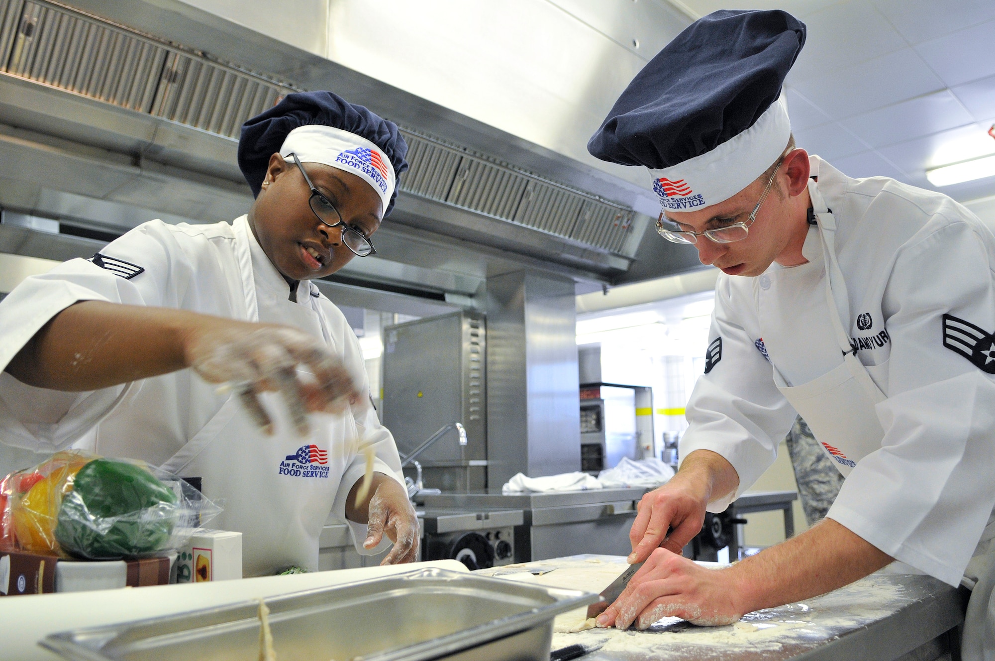 U.S. Air Force Senior Airmen Pamela Underwood and Gary Adamoyurka, 435th Services Squadron chef's, compete in the Top Chef Competition at the Lindberg Hof Dining Facility on Kapaun Air Station June 17, 2009.(U.S. Air Force photo by Staff Sgt. Stephen J. Otero)