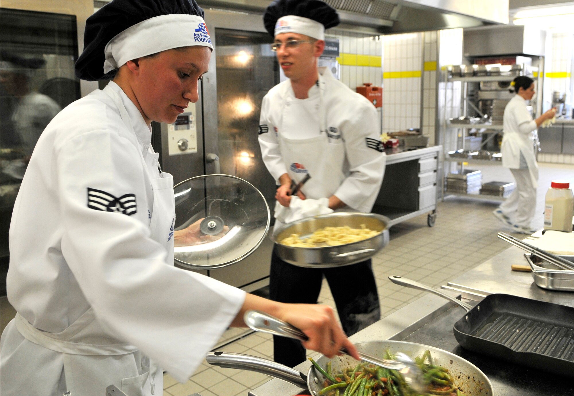 U.S. Air Force Senior Airmen Sheryl Stewart and Gary Adamoyurka, 435th Services Squadron chef's, compete in the Top Chef Competition at the Lindberg Hof Dining Facility on Kapaun Air Station June 17, 2009. (U.S. Air Force photo by Staff Sgt. Stephen J. Otero)