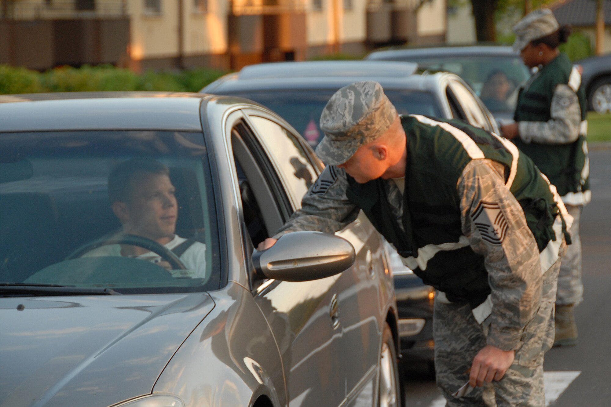 Senior Master Sgt. Scott Miller from the Chief's Group and Staff Sgt. Corina Gross from the Tier Two hand out Ride for Life cards to 52nd Fighter Wing members June 19, 2009, as they exit Bitburg Air Base, Germany. First Sgts.,Top III and First Four members were also on hand from 9 p.m. until 3 a.m. to remind Sabers to be safe and make responsible choices during the weekend.   (U.S. Air Force photo by Senior Master Sgt. Valerie J. Weaver)