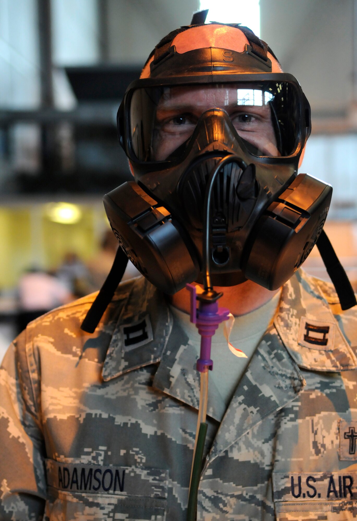 Chaplain (Capt.) Martin Adamson, 100th Air Refueling Wing, tries on the new gas mask at the 100th Logistics and Readiness Squadron as part of a mass issue at RAF Mildenhall June 22.  The new gas mask is designed to be more comfortable and easier to breathe in.  (U.S. Air Force photo by Staff Sgt. Christopher L. Ingersoll)