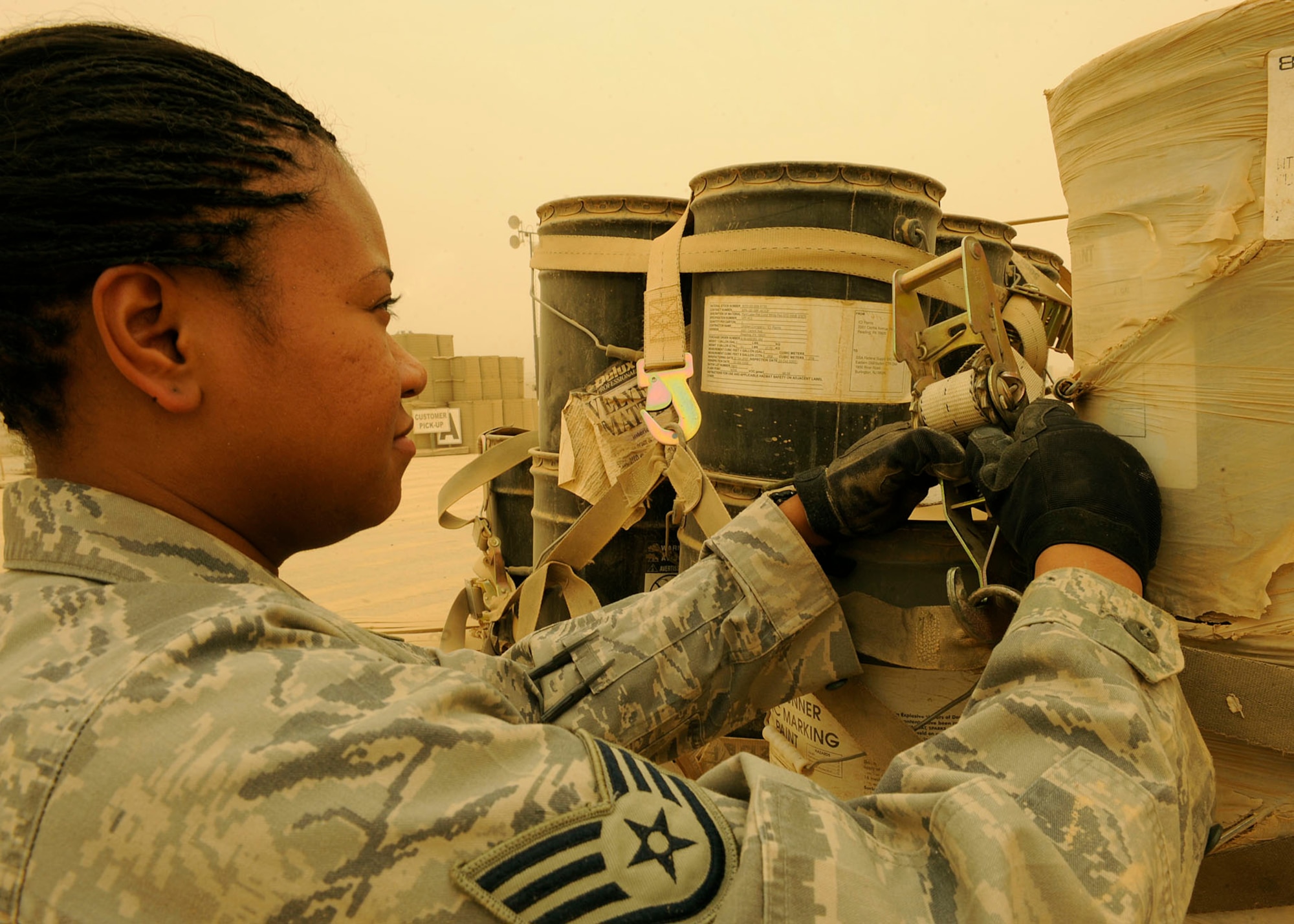Staff Sgt. Starlette McMillan, 22nd Movement Control Team, tightens down the cargo netting on a pallet at Sather Air Base, Iraq June 18, 2009. Sergeant McMillan is part of a 16-person team taking over the mission from the Army’s 258th MCT. The team has only been in country a week and on their second day moved more than 150 pallets. Sergeant McMillan is deployed from Fairchild Air Force Base, Wash., and a native of Silverdale, Wash.  (U.S. Air Force photo by: Senior Airman Jacqueline Romero)