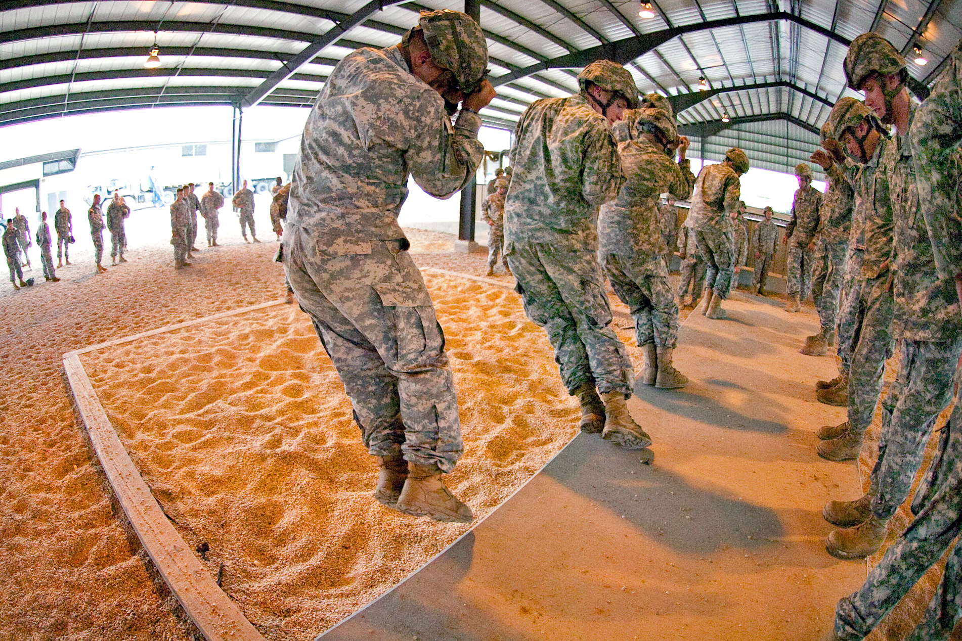 U.S. paratroopers execute parachute landing falls on Pope Air Force Base’s green ramp before a