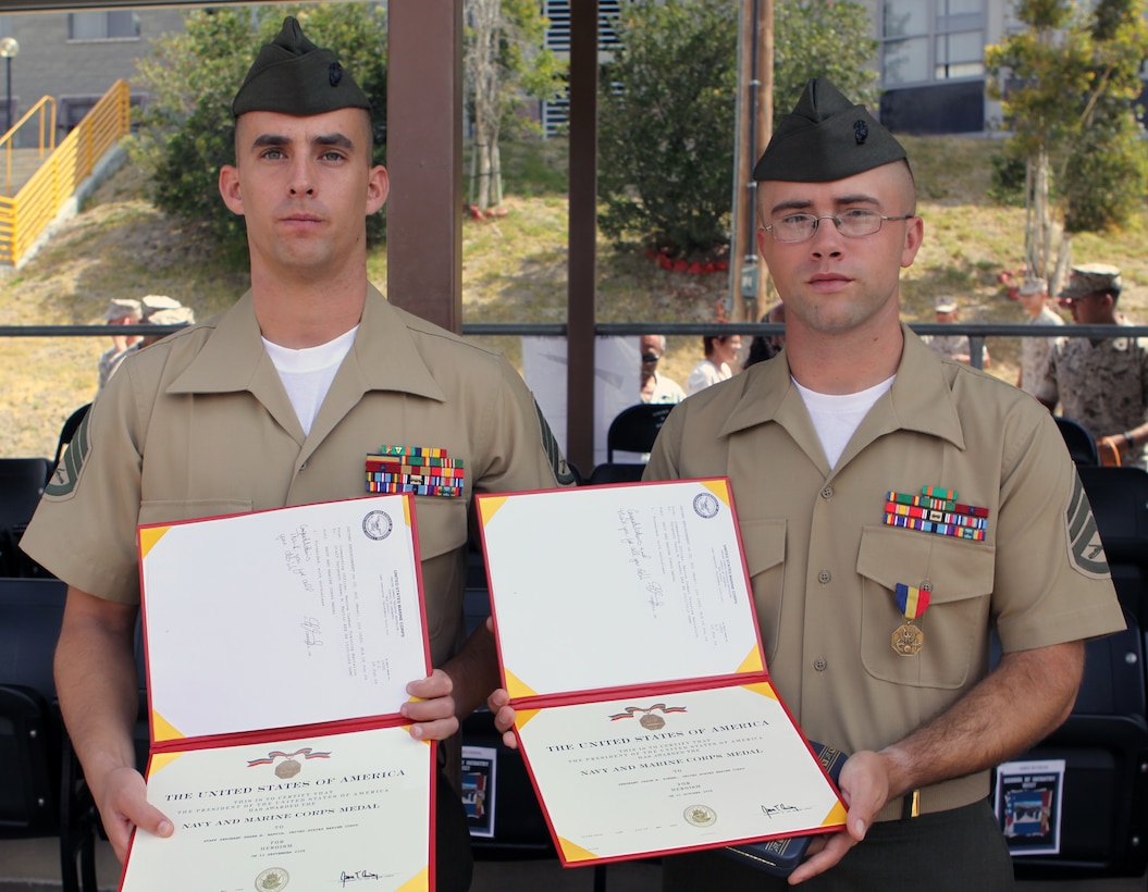 Staff Sgts. Shawn M. Martin (left) and Jason M. Kuehnl (right) were awarded the Navy and Marine Corps Medals during a graduation ceremony at the School of Infantry West, June 23. On two seperate occasions, the Marines immediately responded to improper M67 fragmentation grenade throwing techniques and saved the lives of their students.