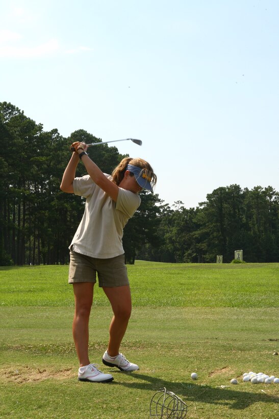 Lynn Healey hits some practice shots while attending the Ladies Clinic sponsored by Paradise Point Golf Course and Marine Corps Community Services in June. The clinic was three days long, and taught the fundamentals, rules and etiquette of golf as well as proper stance, grip, alignment and how to swing.